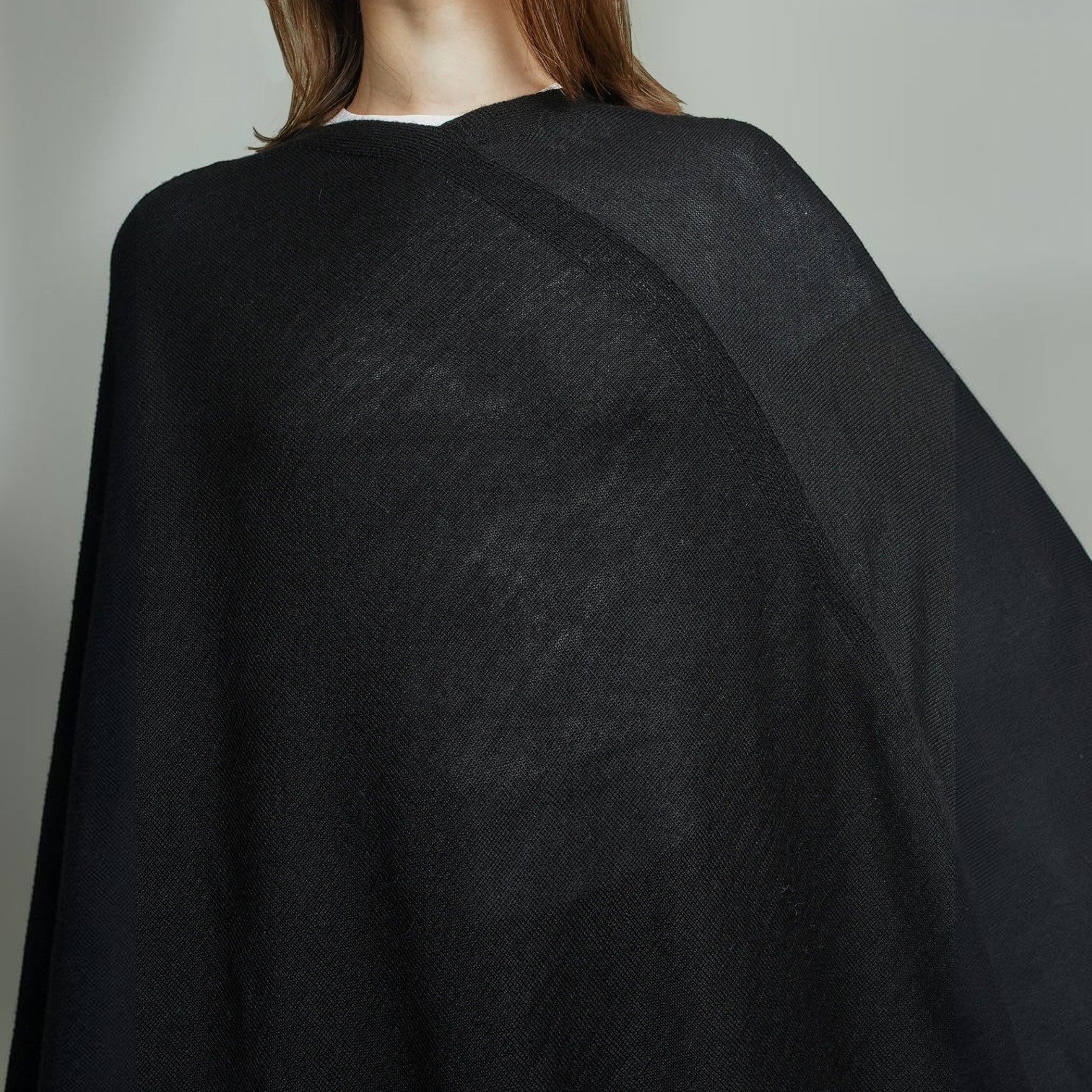 Close Up view of the elegant Almendra poncho in black
