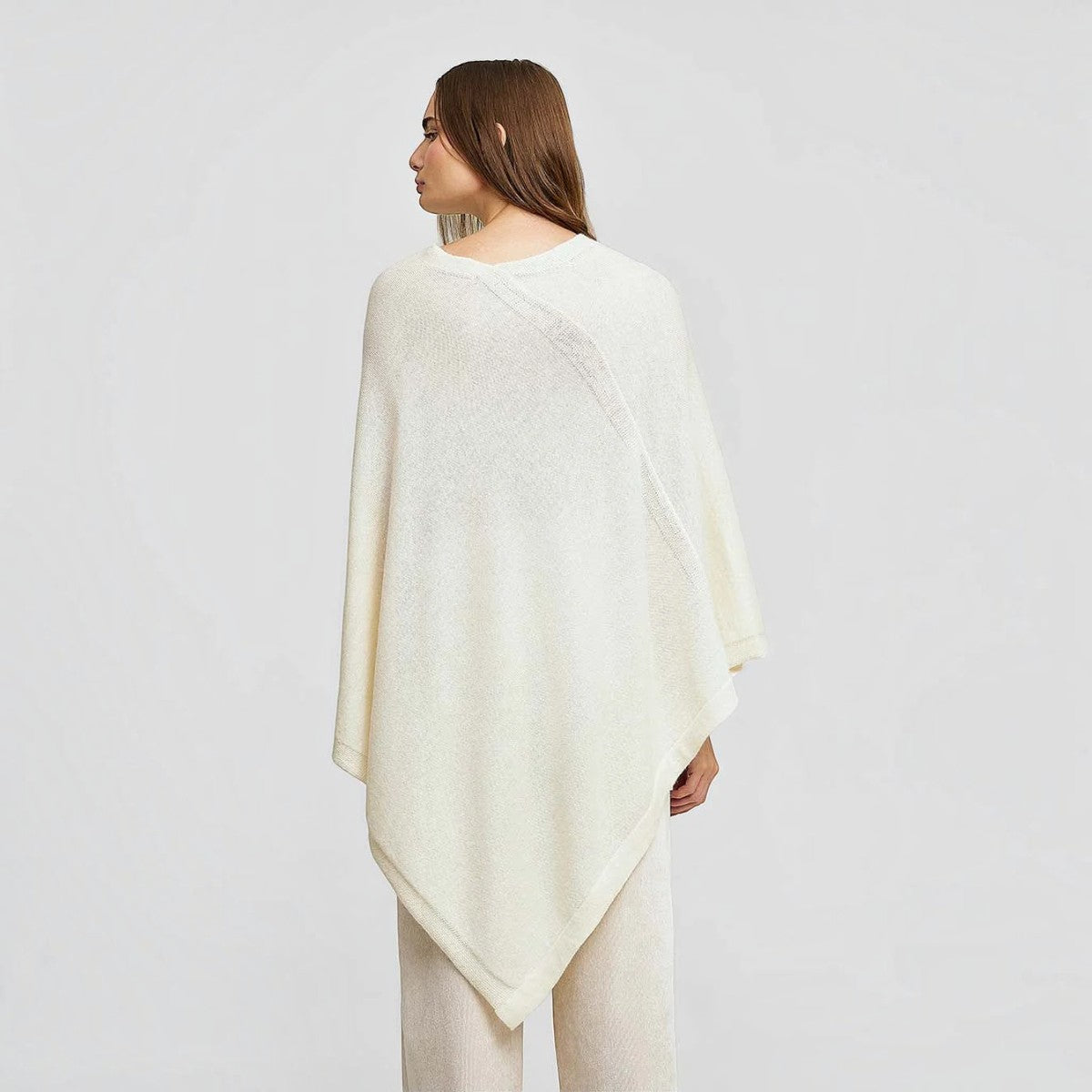 Lightweight cream Baby Alpaca poncho styled with neutral trousers
