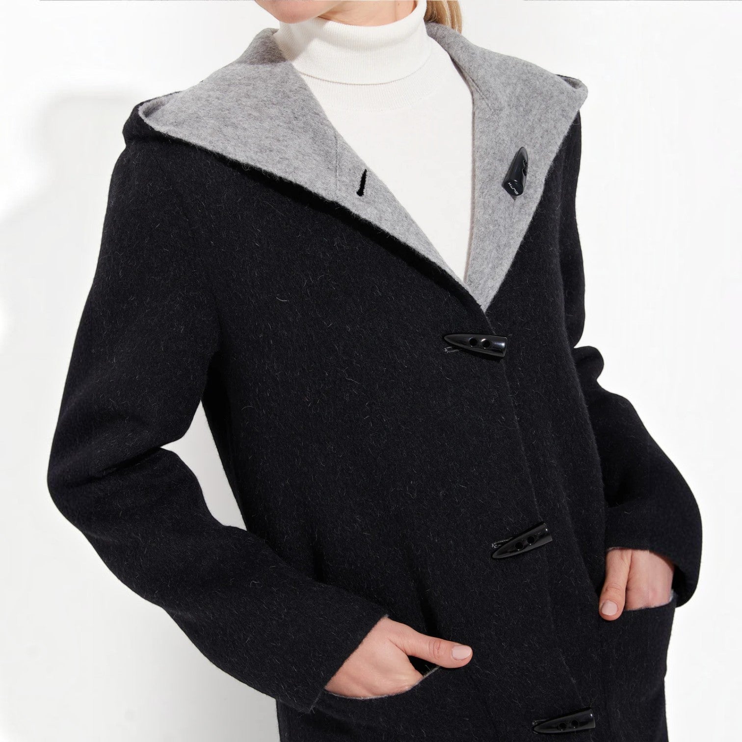 Clsoe up view of reversible baby alpaca coat styled in light grey