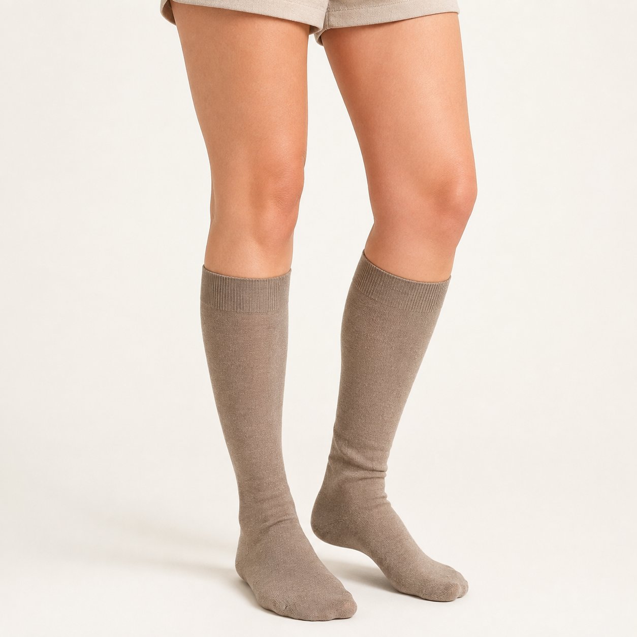 Taupe baby alpaca blend knee-high socks with ribbed cuffs on a white background.