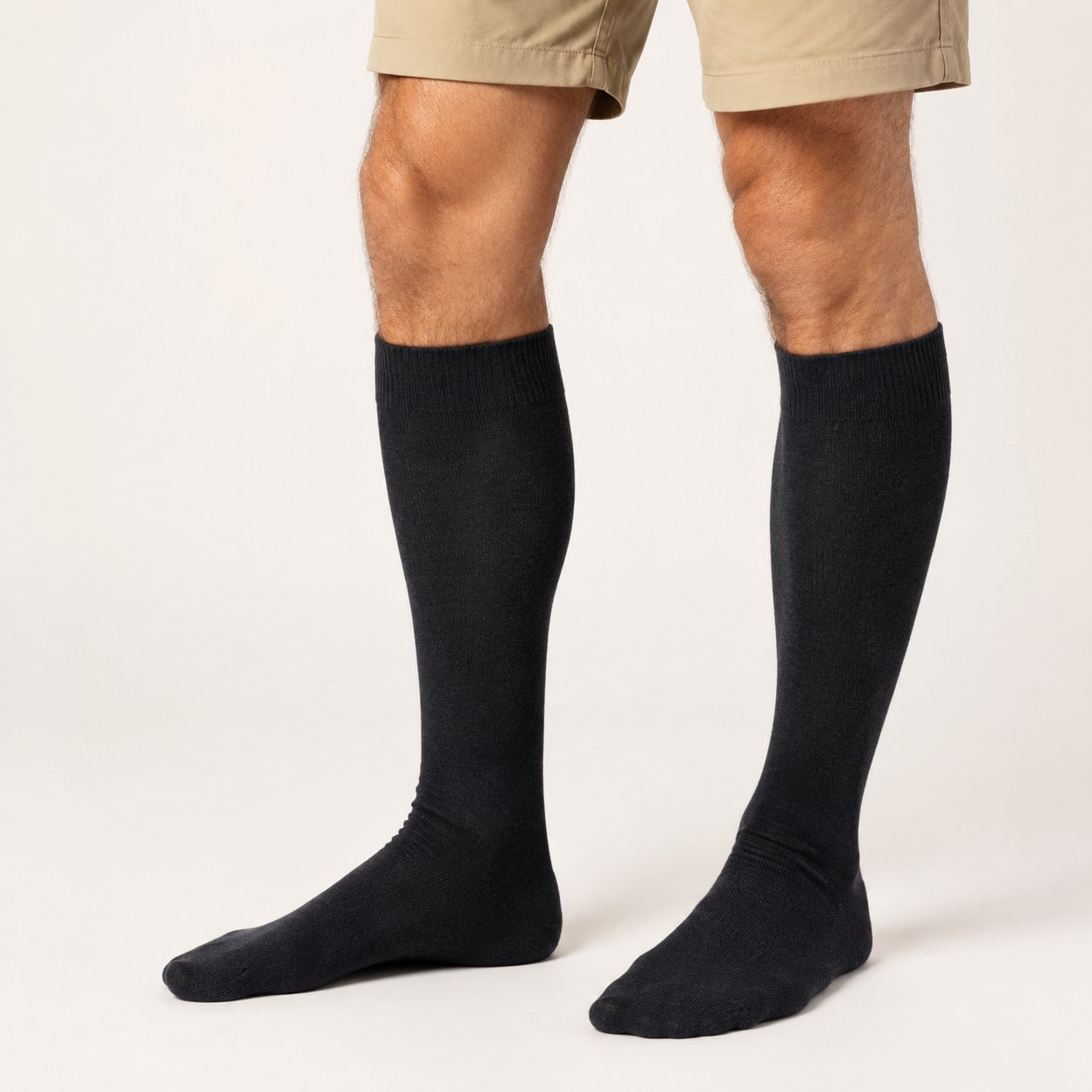Black baby alpaca blend knee-high socks with ribbed cuffs on a white background.