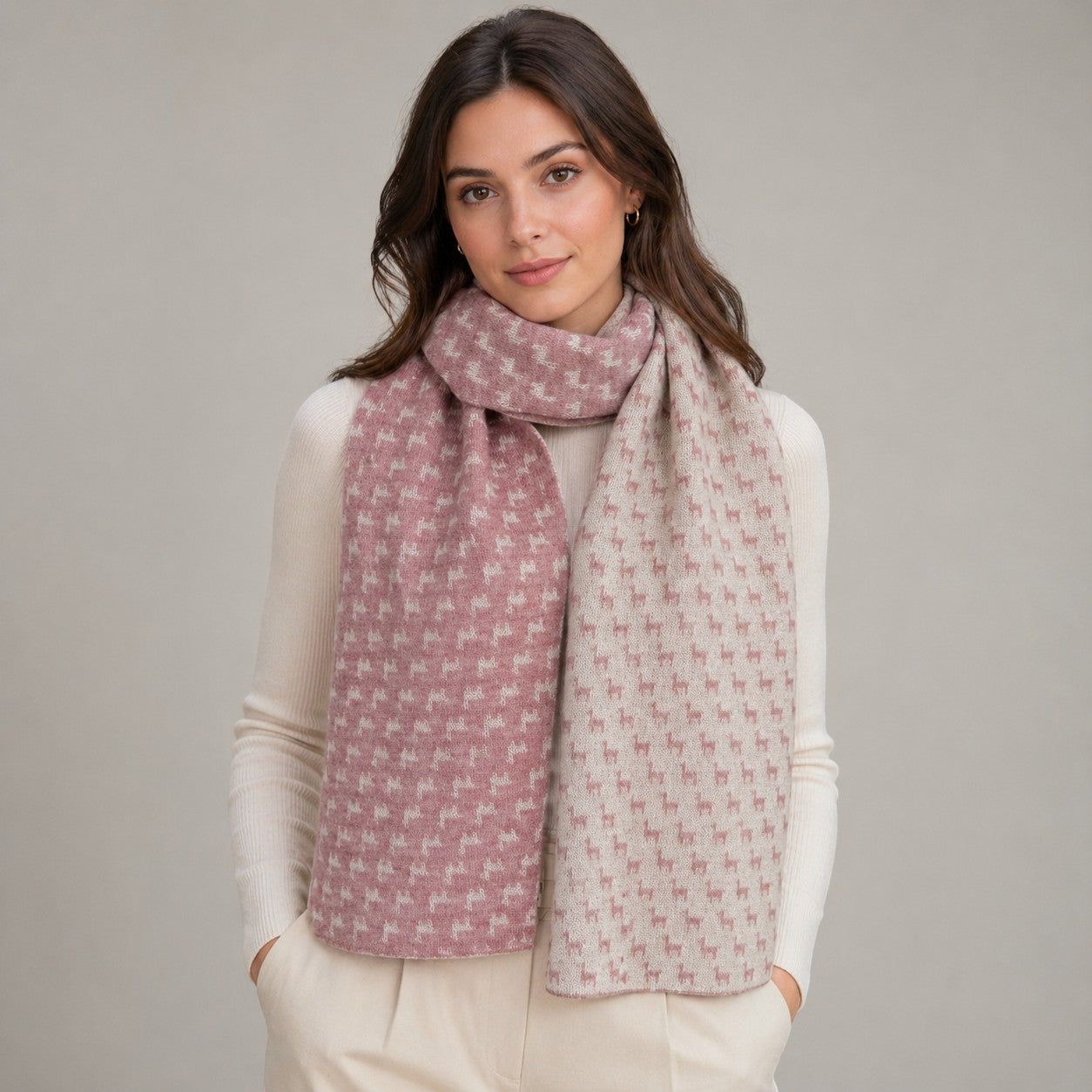 Reversible alpaca scarf featuring woven alpaca motifs in pink and cream