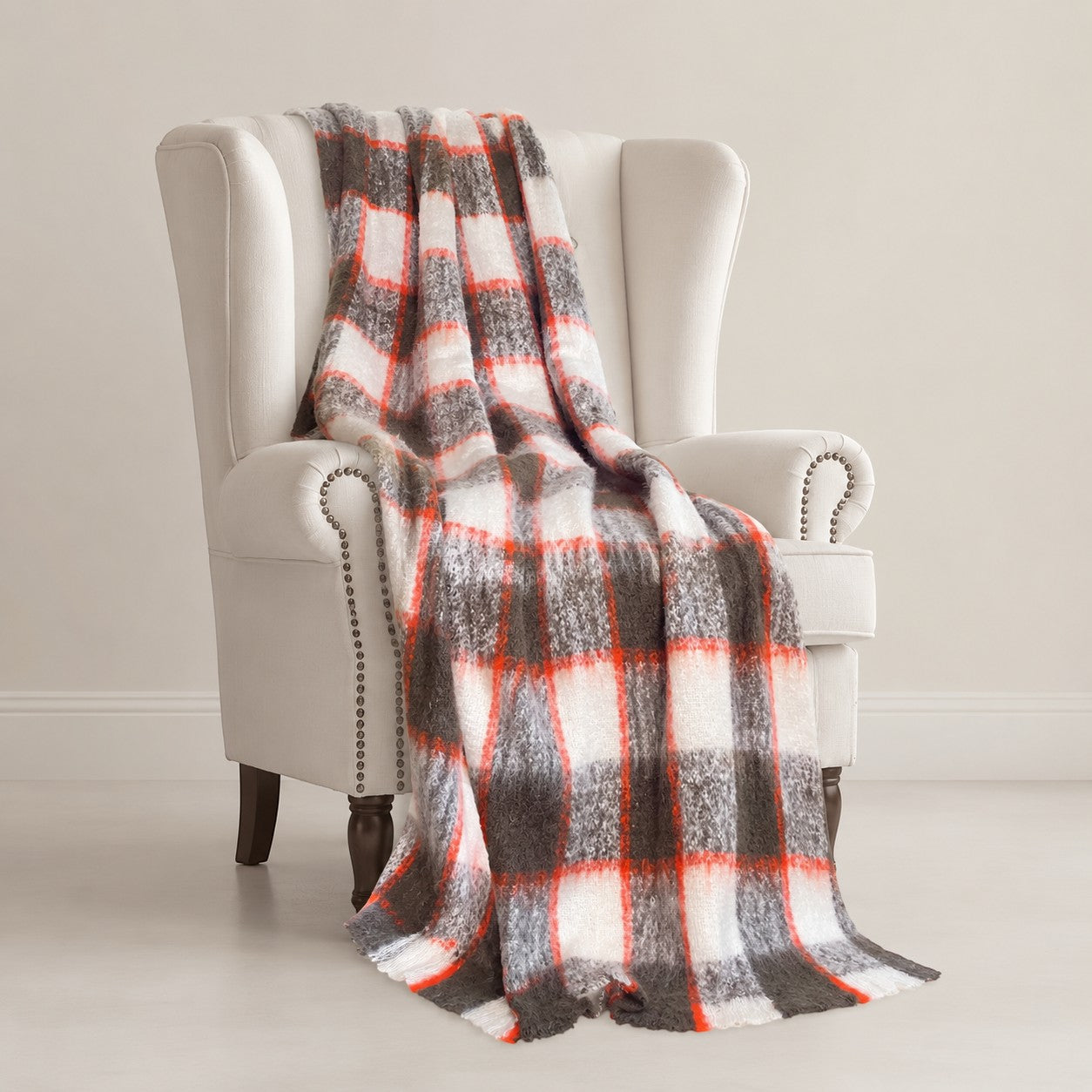 Soft brushed alpaca throw draped over winged chair, luxury natural fibre home decor.