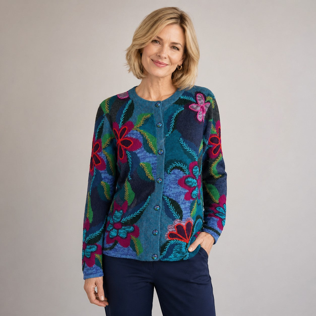 Woman wearing a colourful floral-patterned alpaca cardigan with matching buttons