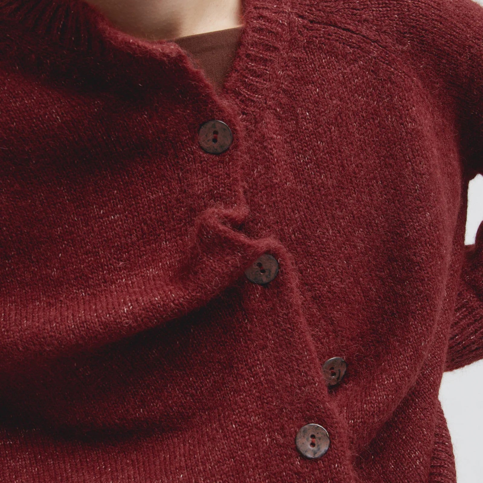 Close up of Kuna Celeste luxury alpaca cardigan with natural lustre and long sleeves