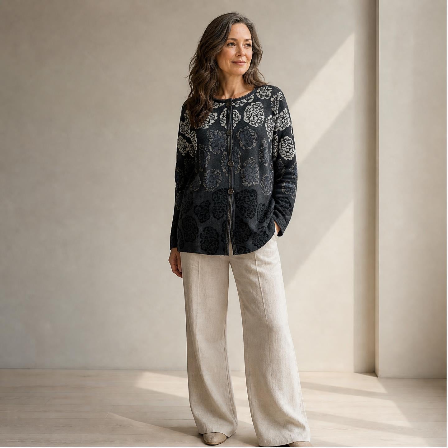 Female model wearing patterned alpaca cardigan with large chrysanthemum flowers