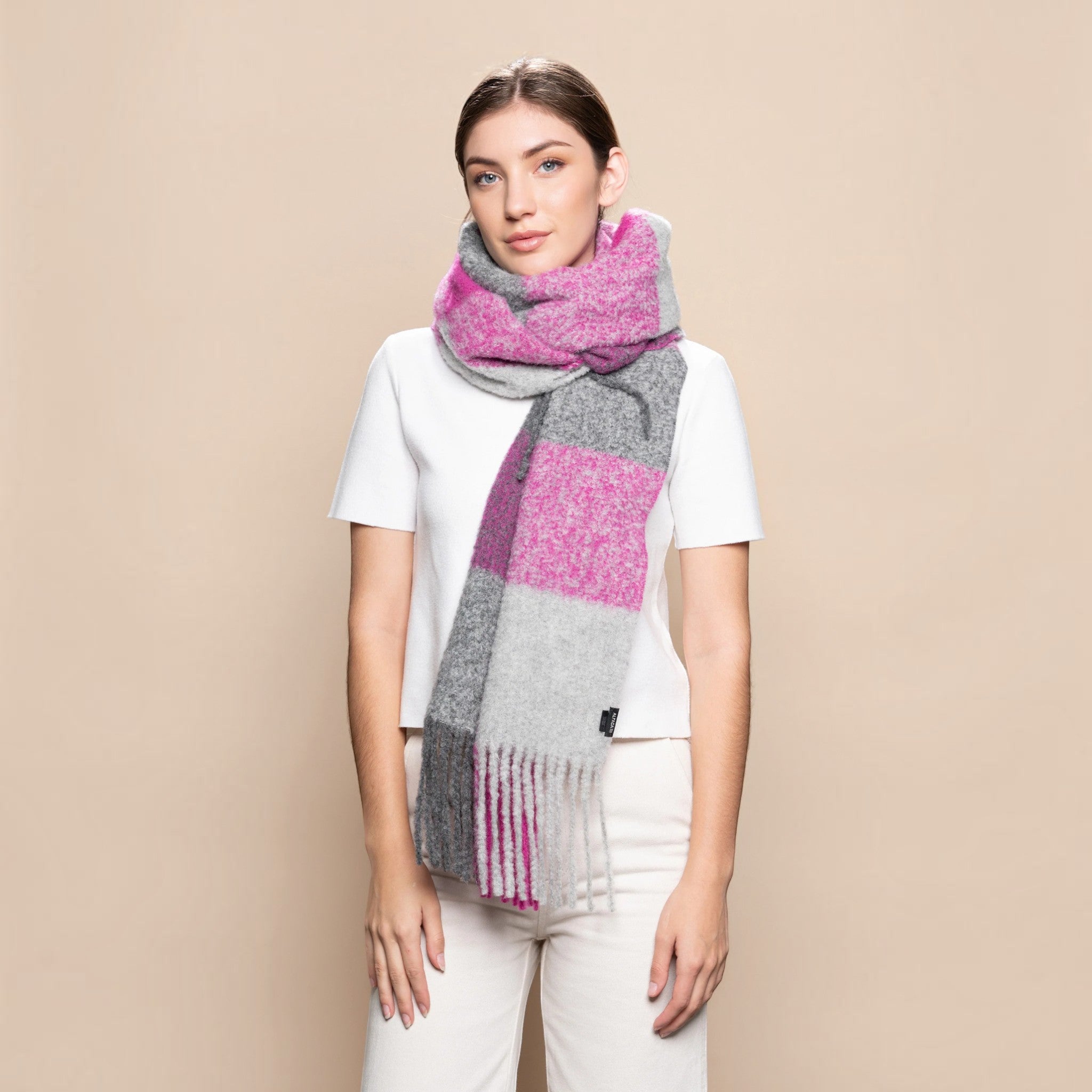 Woman wearing a chunky fuchsia and grey alpaca blend scarf