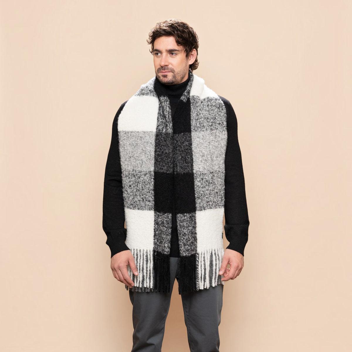 Man wearing a chunky black, grey and white alpaca blend scarf
