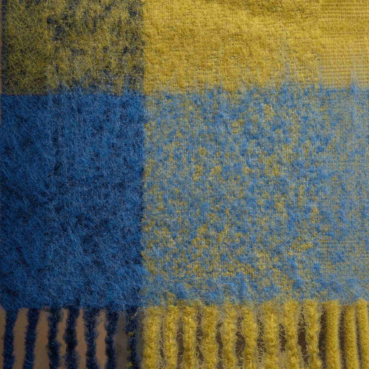 Swatch of Navy, blue and green oversized plaid alpaca scarf with fringe