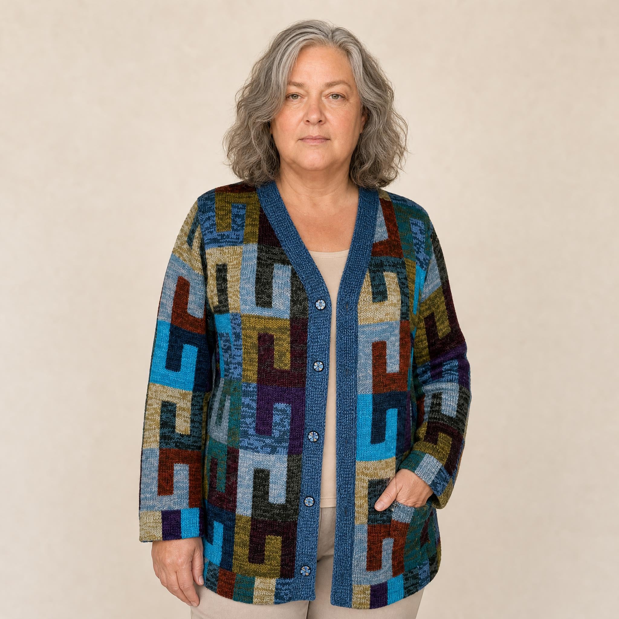 Model wearing Joanna long hand knitted alpaca cardigan with geometric pattern