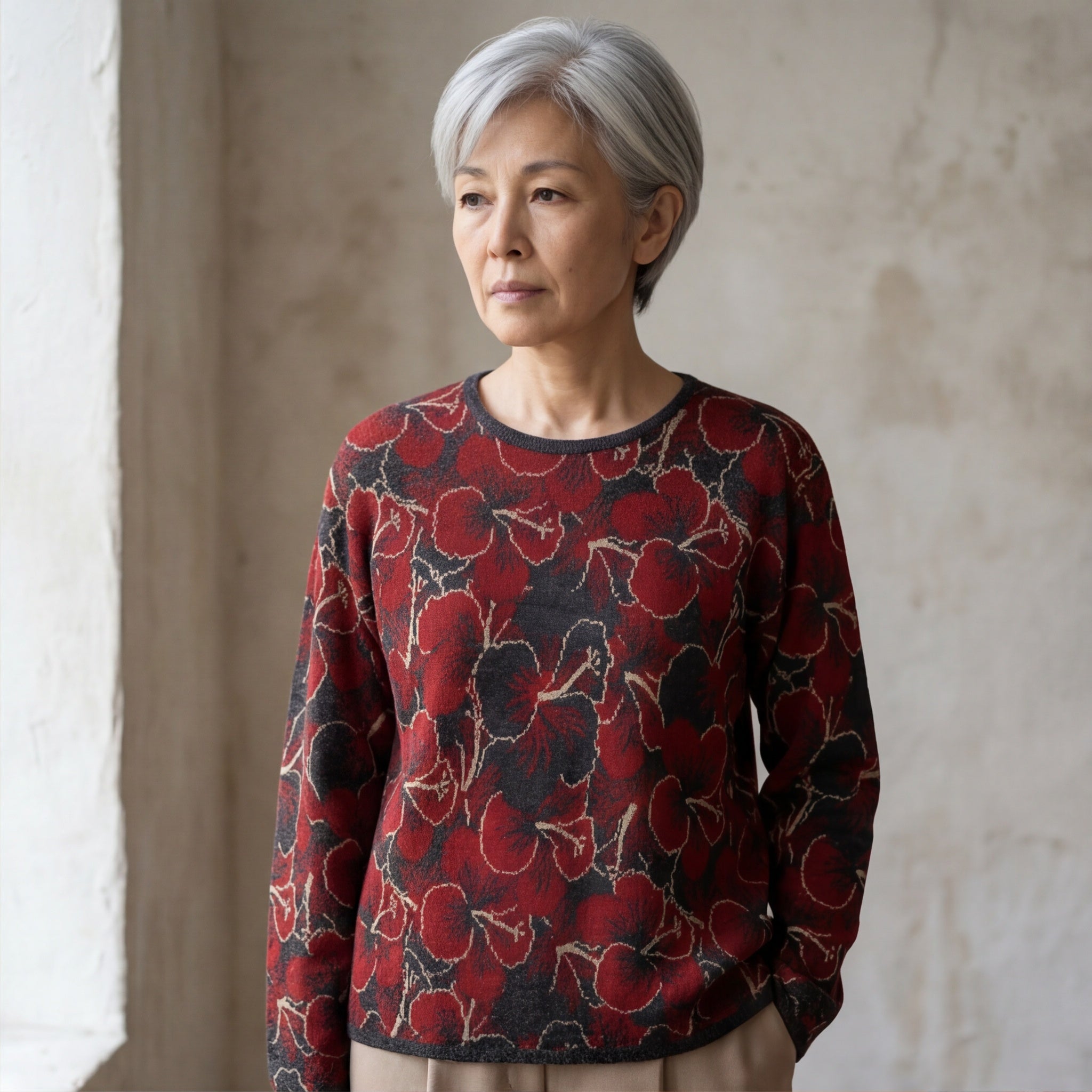 Hibiscus alpaca sweater with red floral design on charcoal base