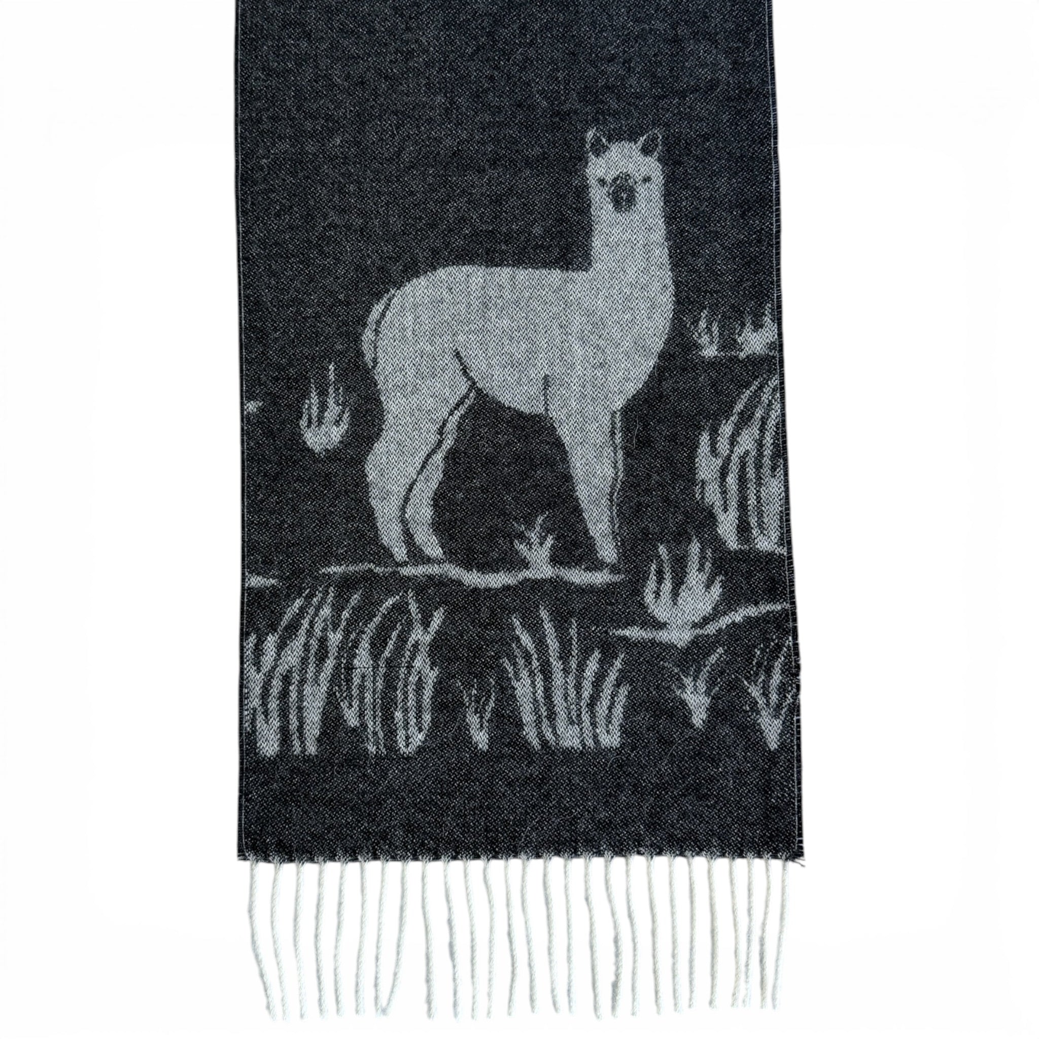 Soft alpaca scarf with a black and white woven animal motif and tasselled ends