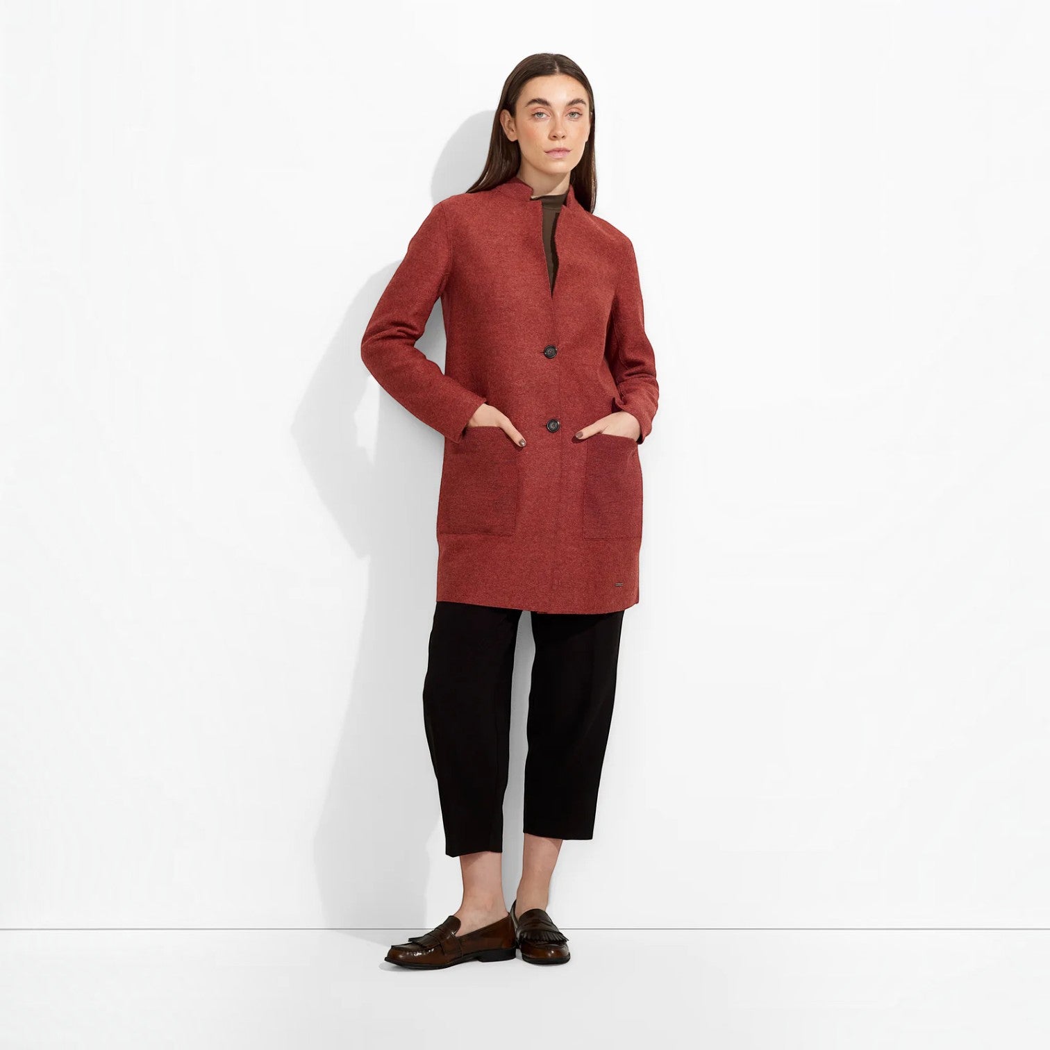 Back view of women’s red alpaca coat with long sleeves and high collar