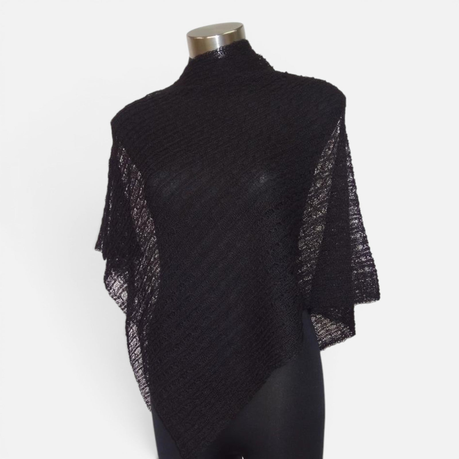 Black lacy alpaca poncho shown from the back with soft drape and open-knit texture