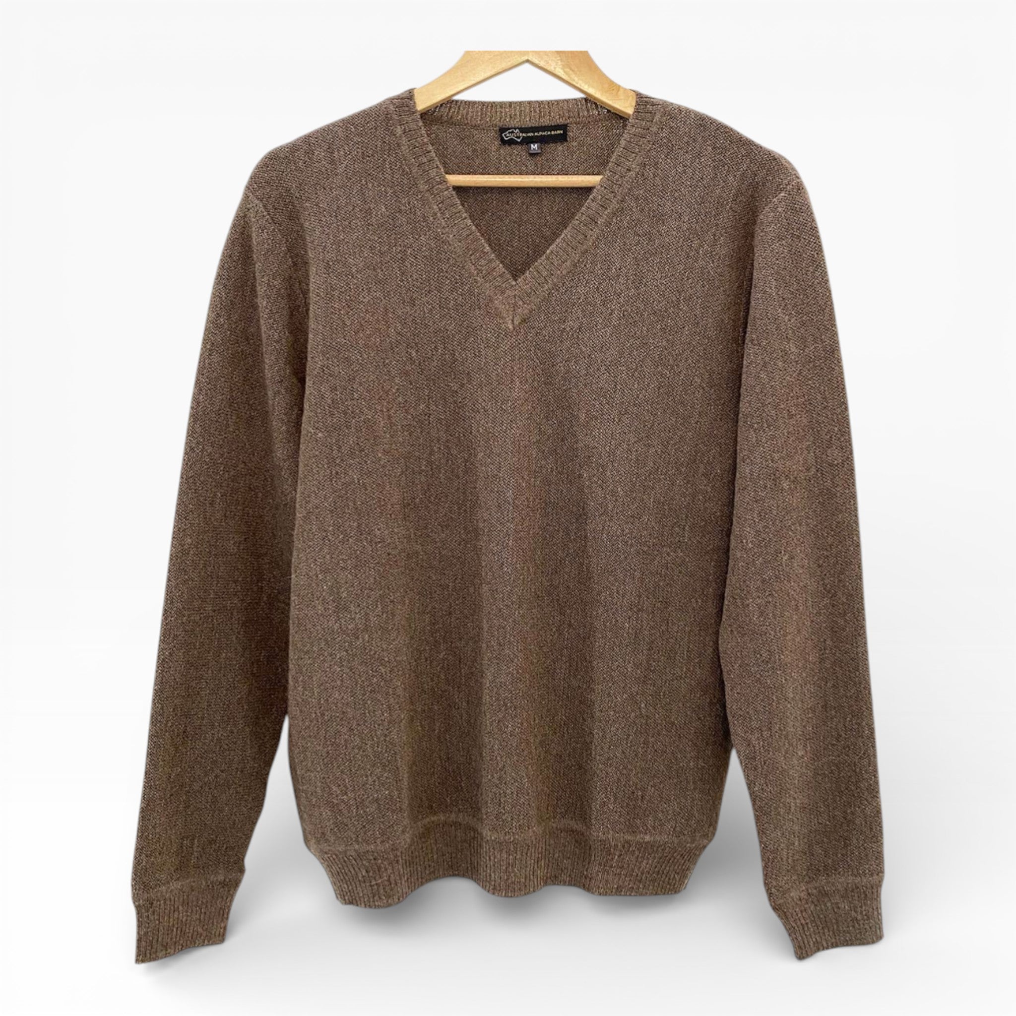 Brown V neck sweater on hanger on white background