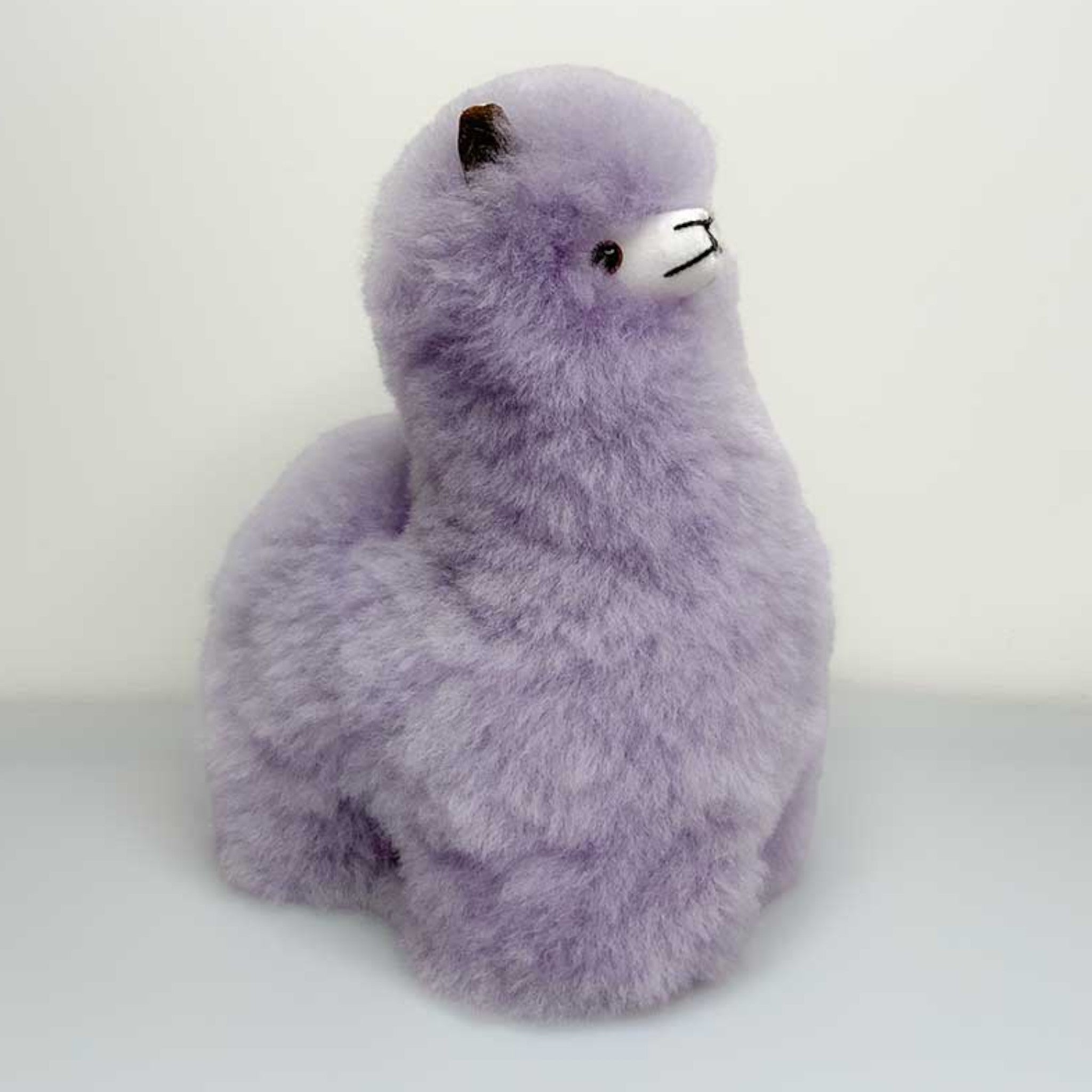 Soft alpaca fur alpaca toy in purple, fluffy gift.