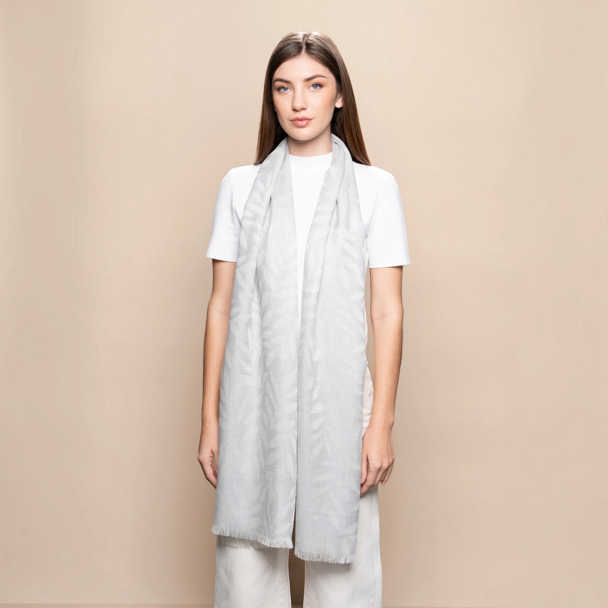 Light grey Leaf Jacquard Baby Alpaca and Silk scarf styled long with subtle woven leaf pattern and frayed edges