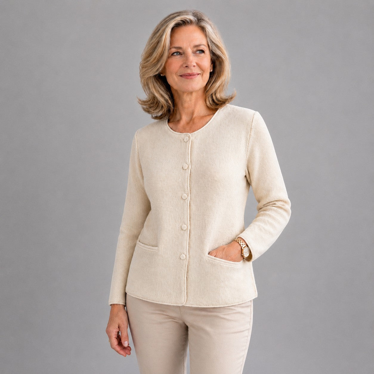 Woman wearing soft cream alpaca cardigan with buttons, styled for winter.