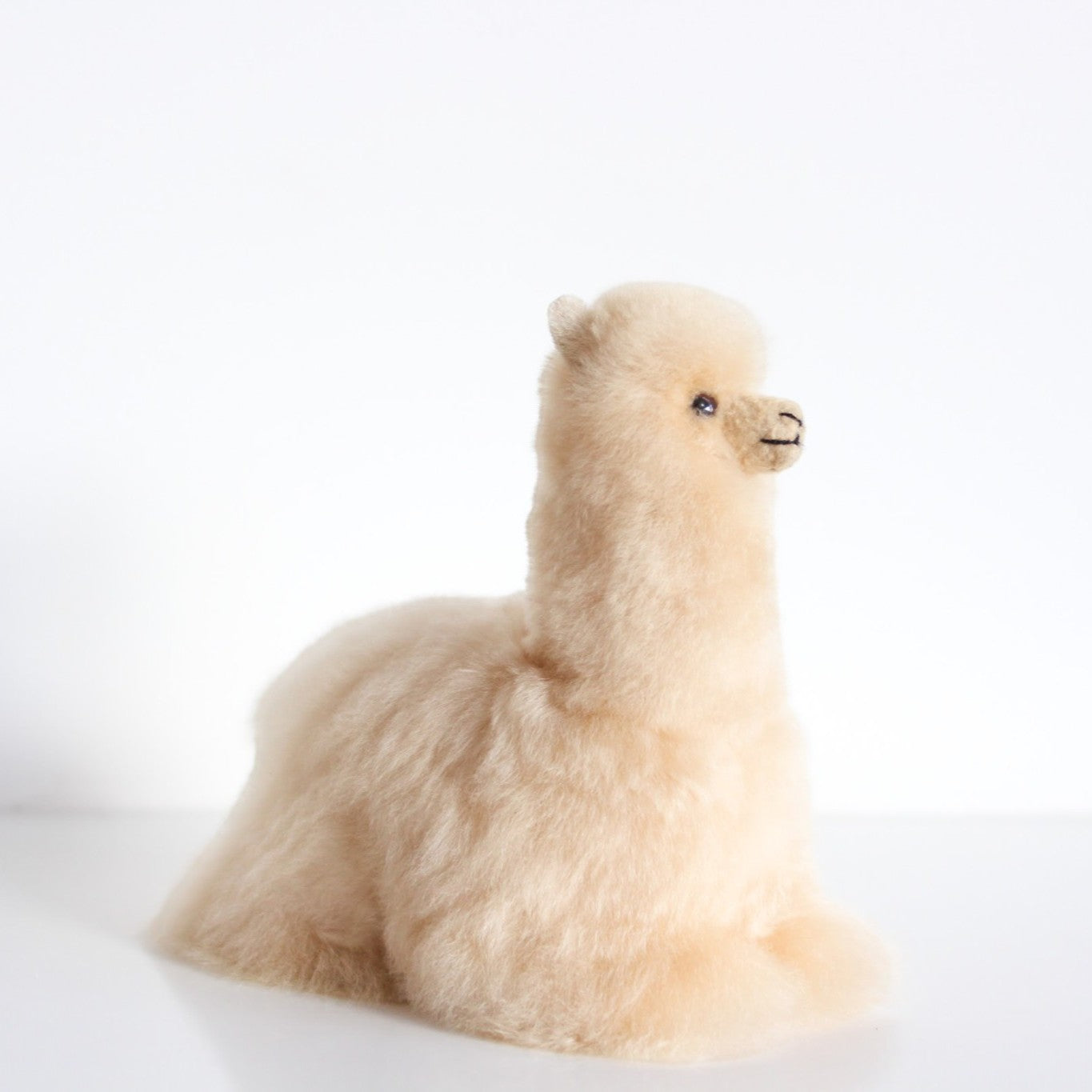 Lying Huacaya alpaca fur figure handcrafted in Peru from soft natural alpaca fur
