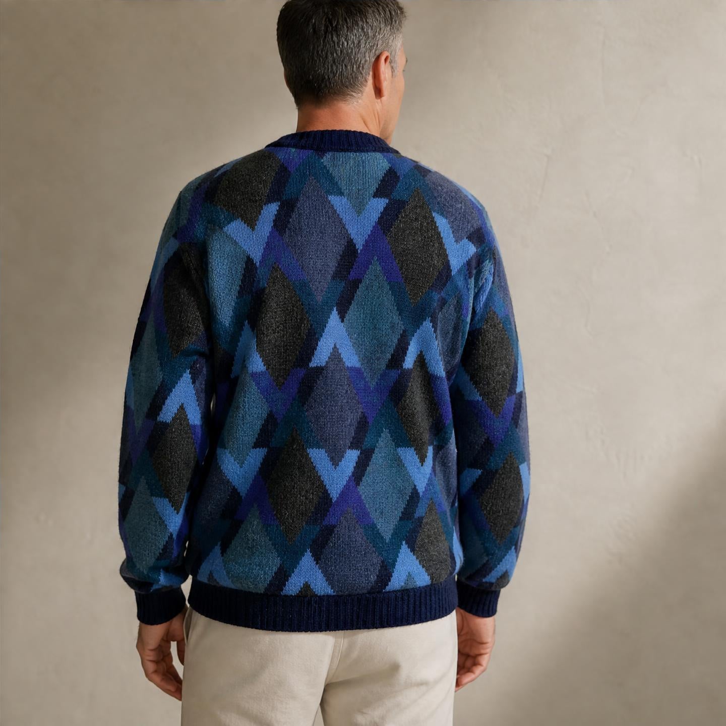 Model wearing Blue patterned men’s alpaca sweater with multicolour knit design