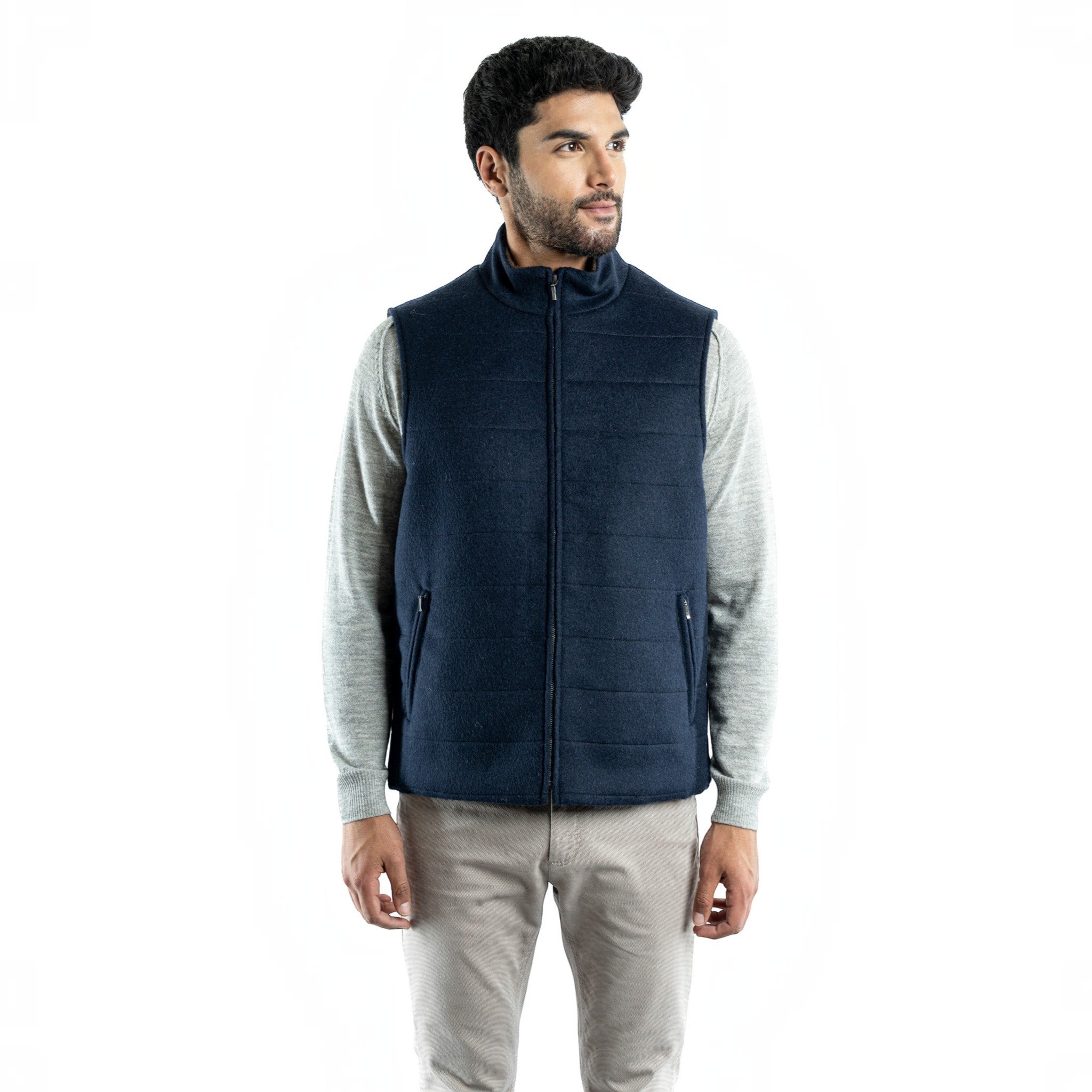 Navy alpaca wool vest shown in a three-quarter view with zippered pockets