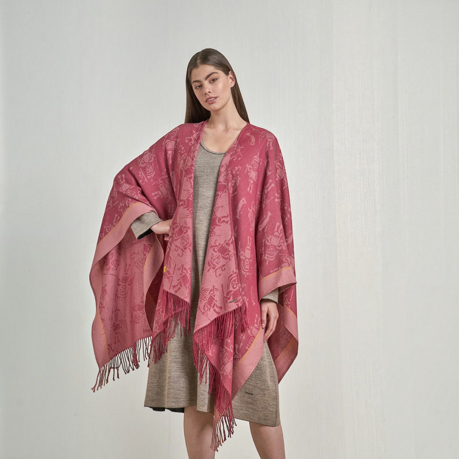 Women’s Nazca fuchsia royal alpaca cape with woven Andean-inspired motifs and fringed edges