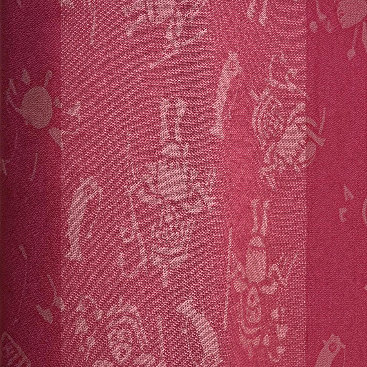Close-up of the fuchsia royal alpaca fabric with woven cultural motifs