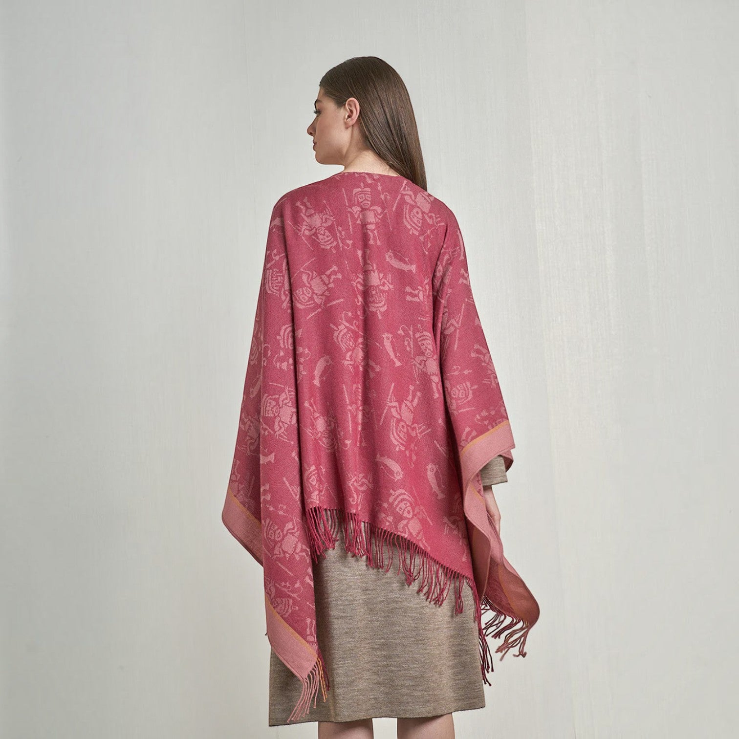 Back view of the Nazca fuchsia alpaca cape showing its flowing drape and patterned design