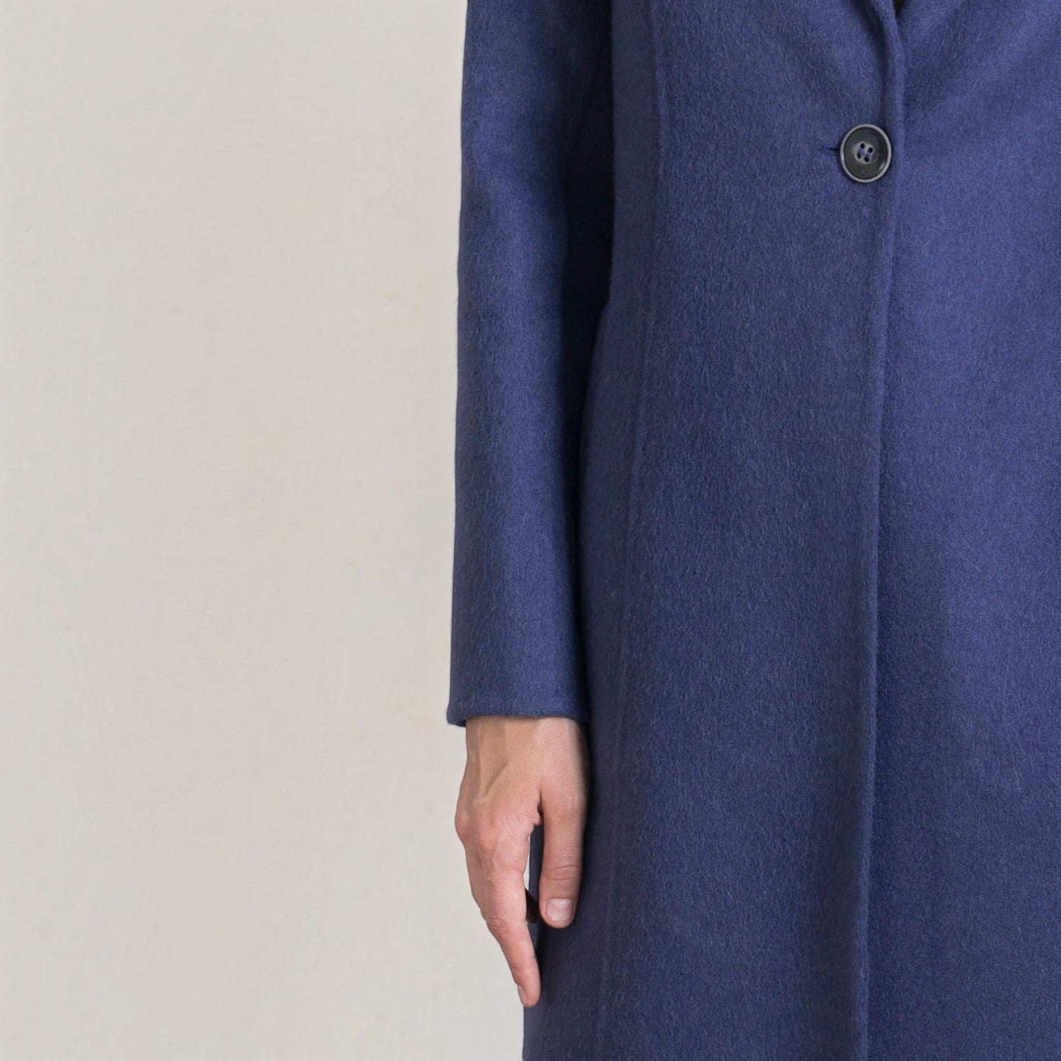 Close-up of the Refugio coat showing the soft blue baby alpaca texture and button closure