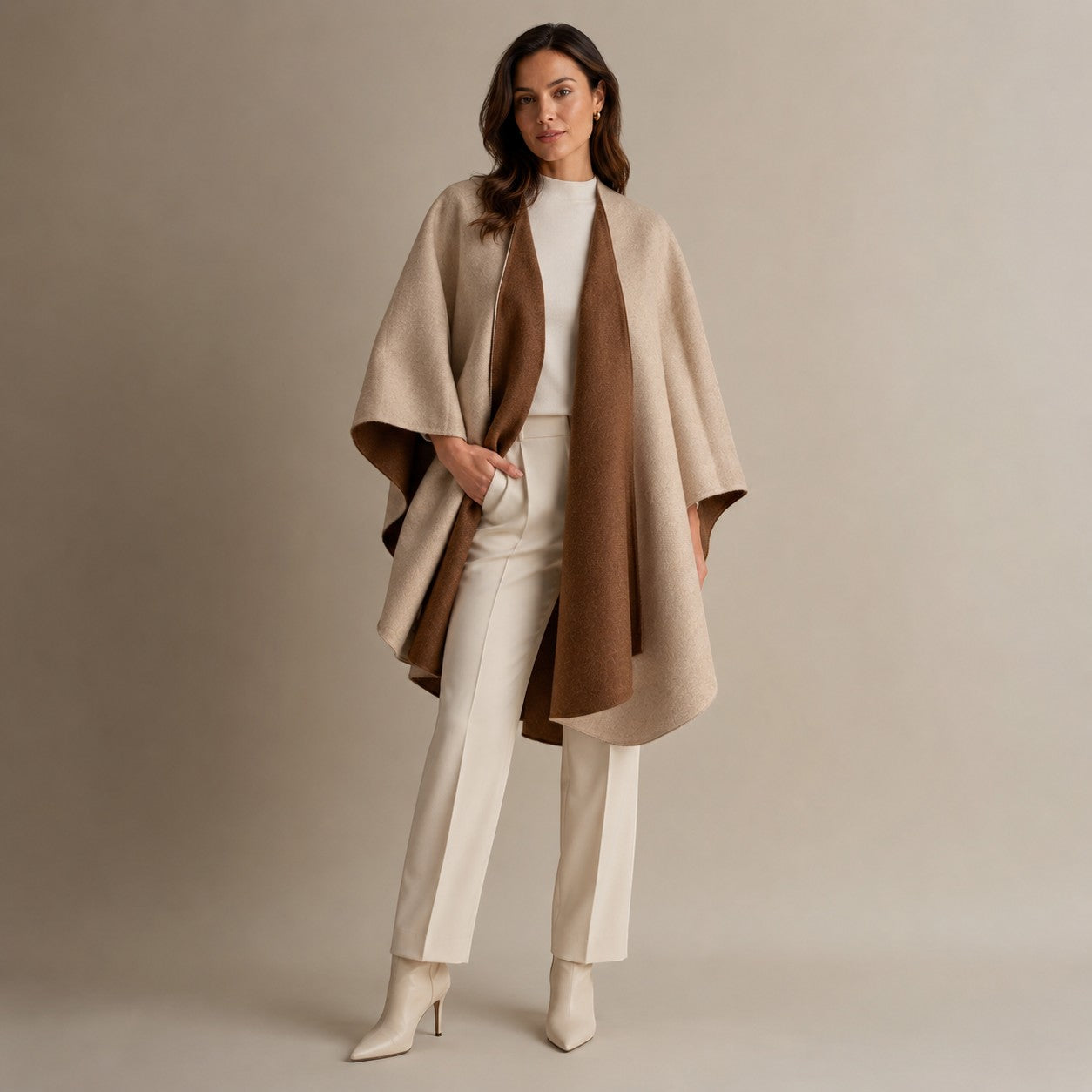 Brown reversible cape styled over neutral clothing, showing the contrasting beige reverse side.