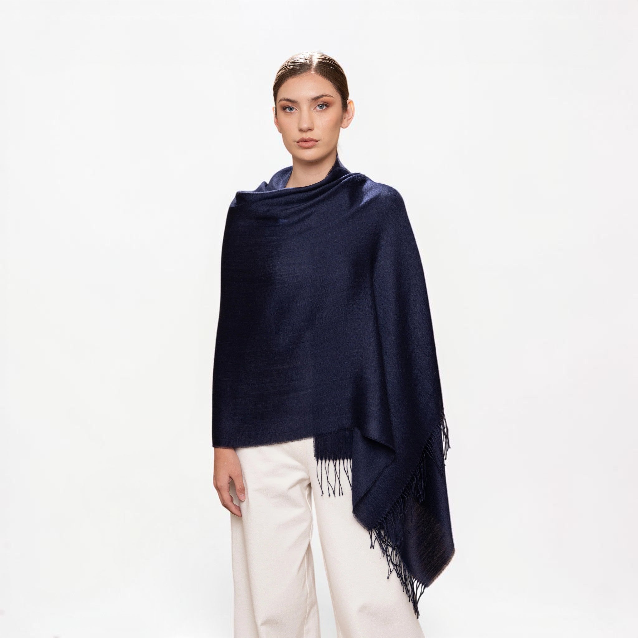 Alpaca and silk Navy shawl worn over the shoulders, soft luxury layering piece.