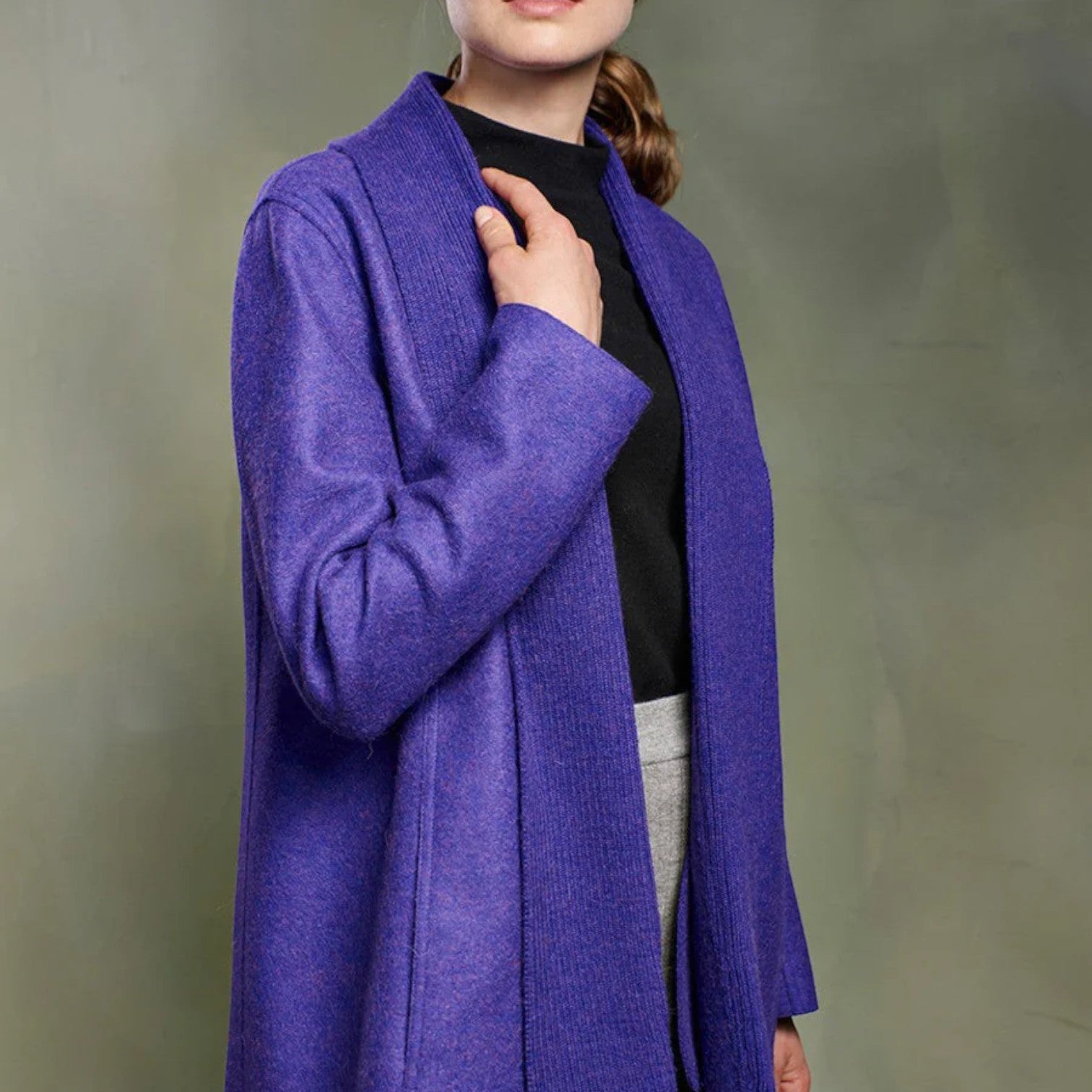 Close-up of the Tamesis coat showing the purple alpaca wool texture and knitted collar