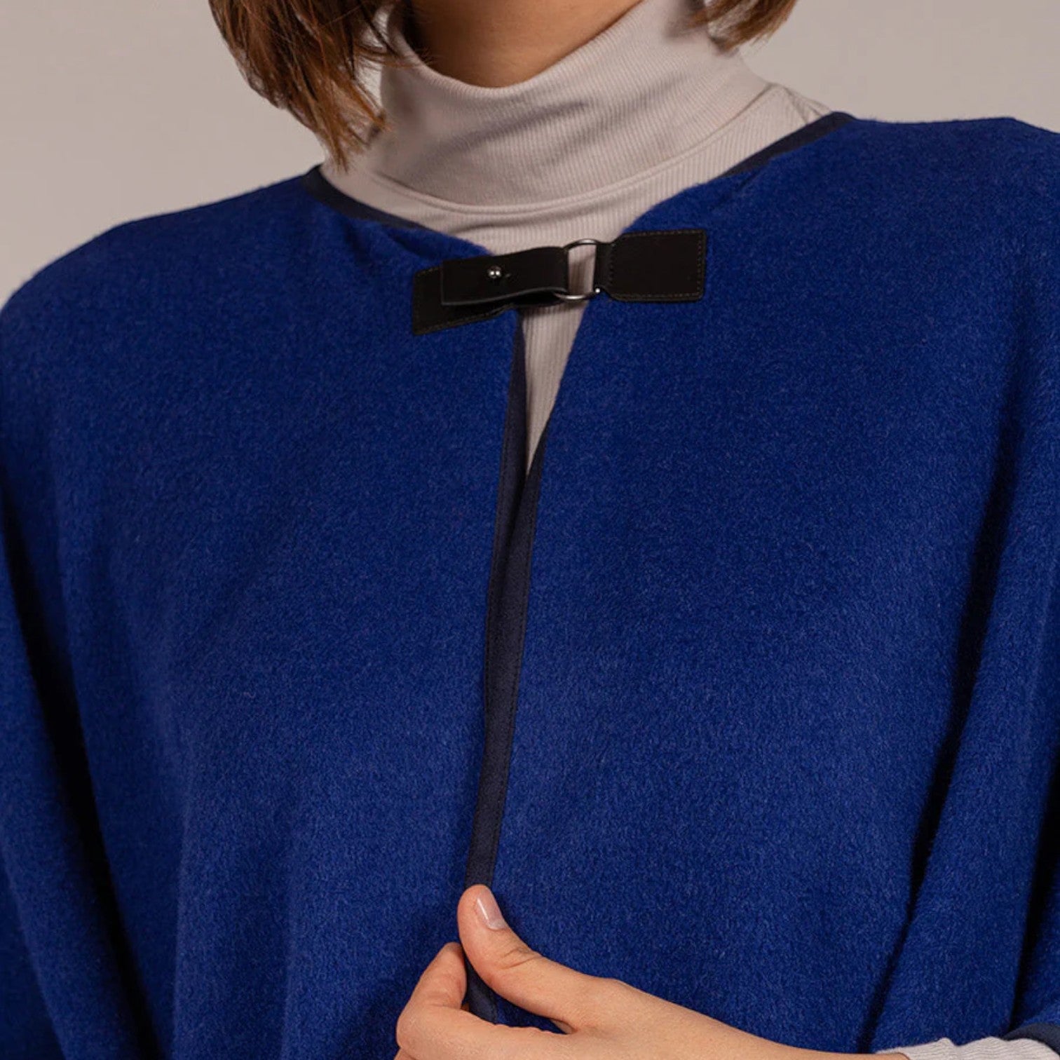 Women’s royal blue baby alpaca cape with front clasp and contrast edging