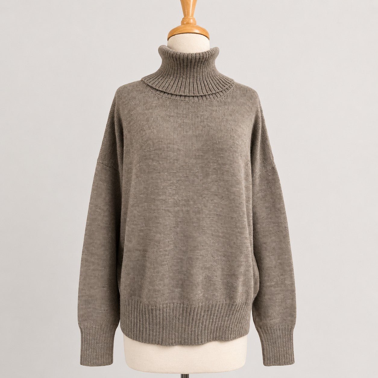 Ladies alpaca turtleneck sweater in neutral beige, soft warm winter knitwear.