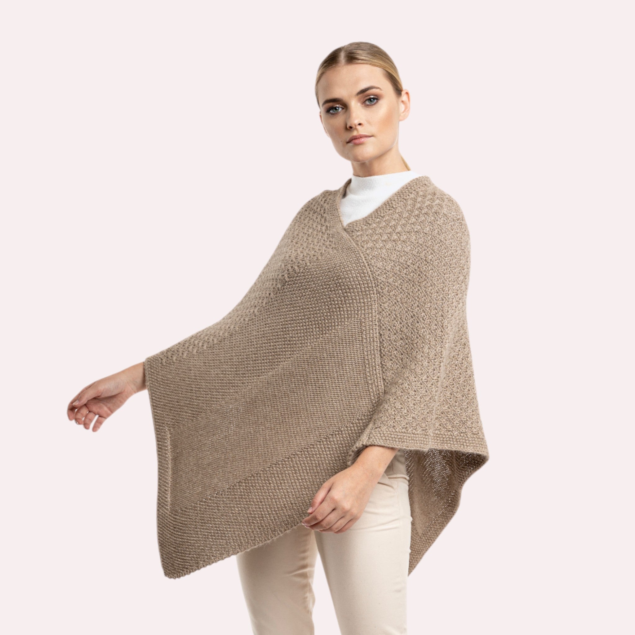 Knitted alpaca poncho in beige, soft warm winter layering piece.
