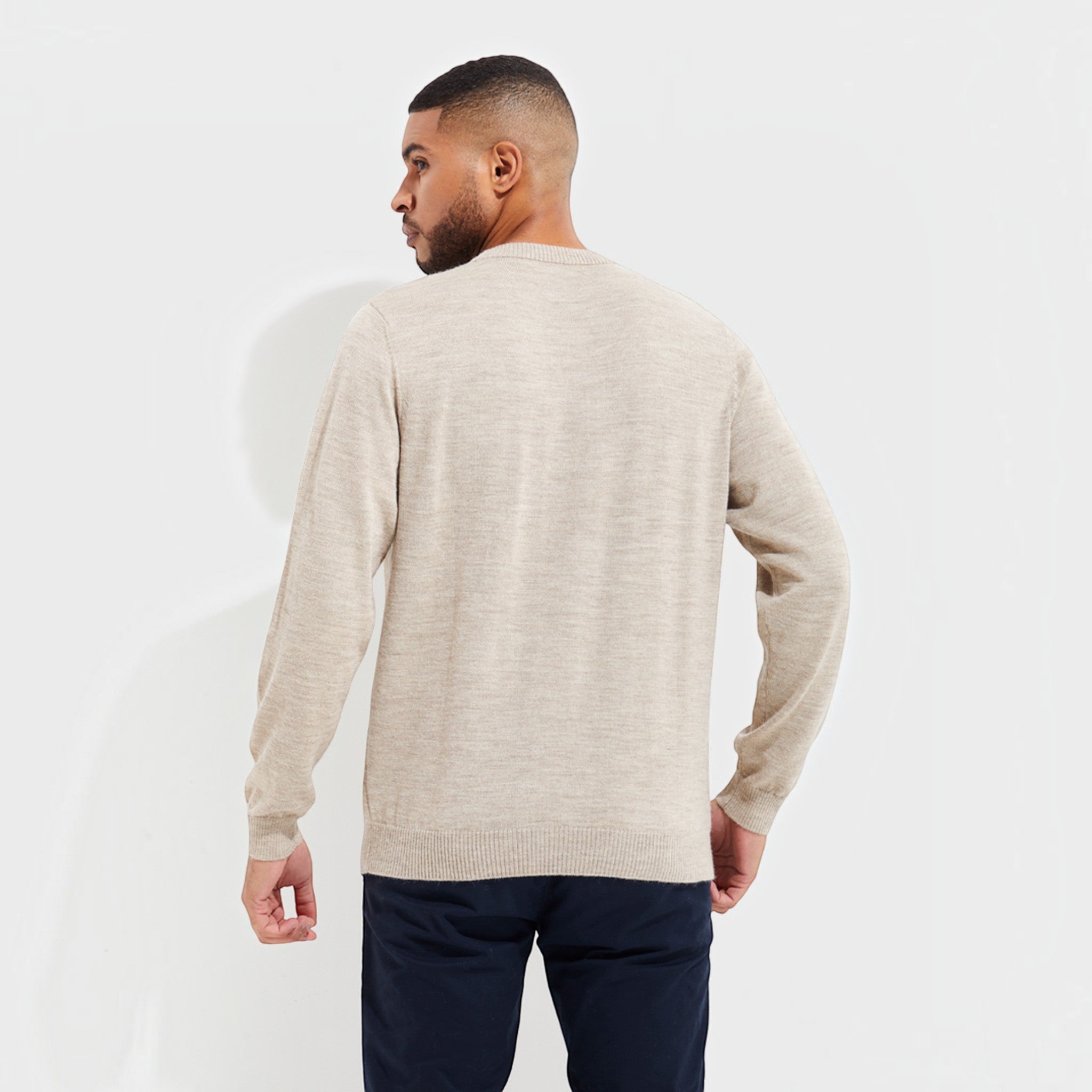 Model wearing a beige 100% Baby Alpaca crew-neck sweater