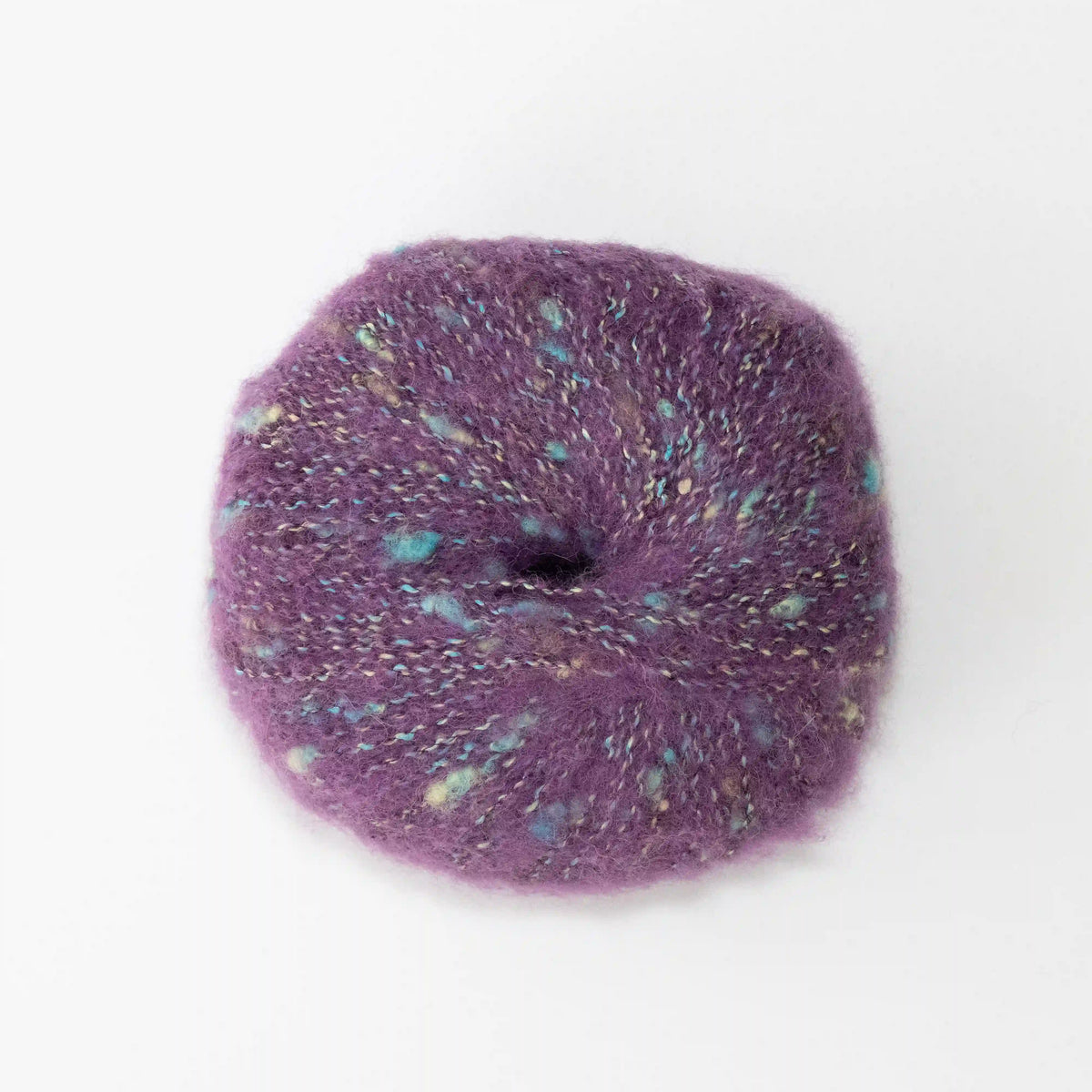Overhead view of Amethyst Indulge baby alpaca bouclé yarn without a label.