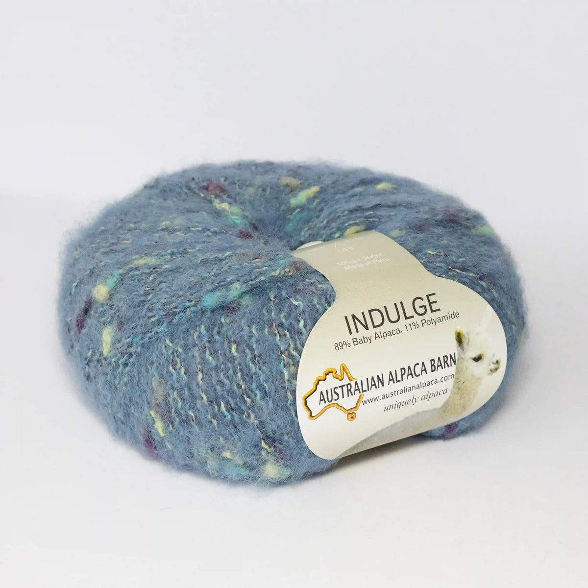 Aqua Indulge baby alpaca bouclé yarn with its product label visible.