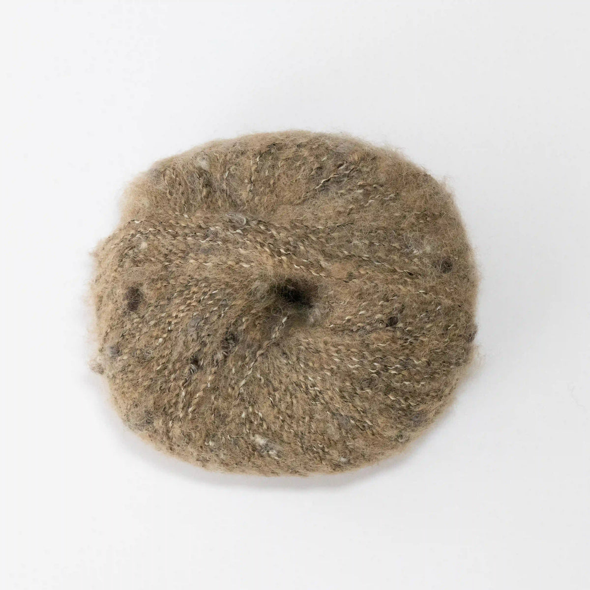 Overhead view of Camel Indulge baby alpaca bouclé yarn without a label.