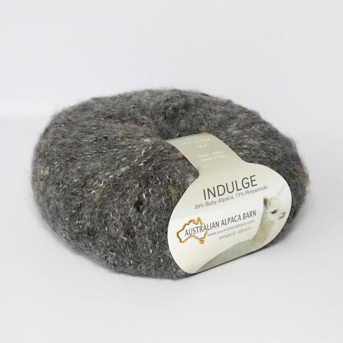 Charcoal Indulge baby alpaca bouclé yarn with its product label visible.