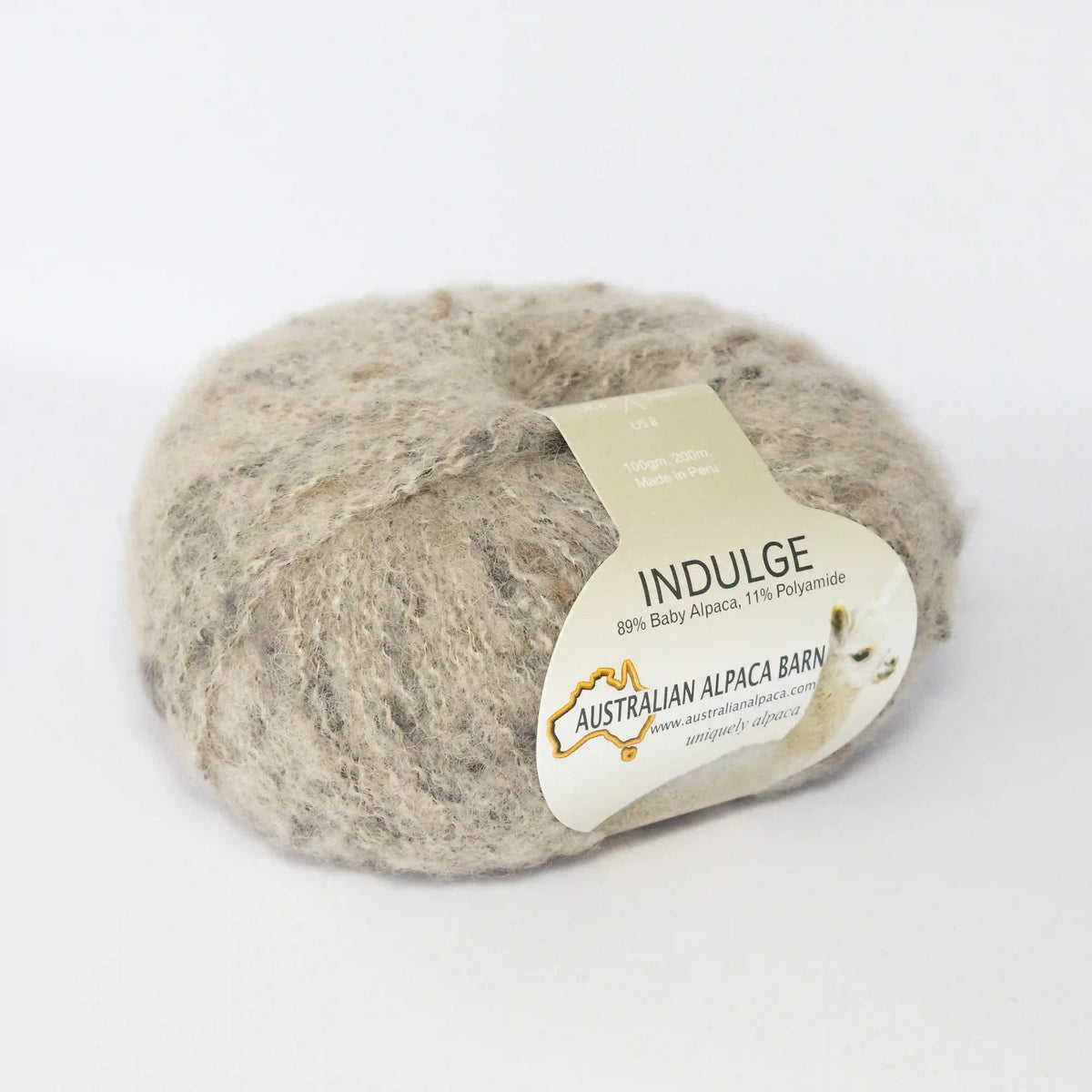 Nougat Indulge baby alpaca bouclé yarn with its product label visible.