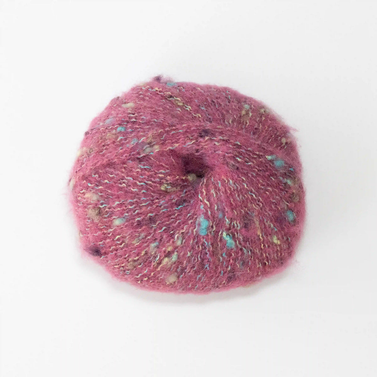 Overhead view of Pink Indulge baby alpaca bouclé yarn without a label.