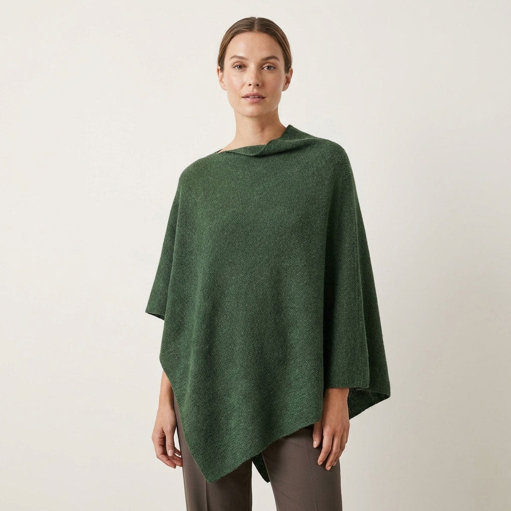 Sorpresa alpaca poncho in Green Melange, a textured green shade, shown on a female model