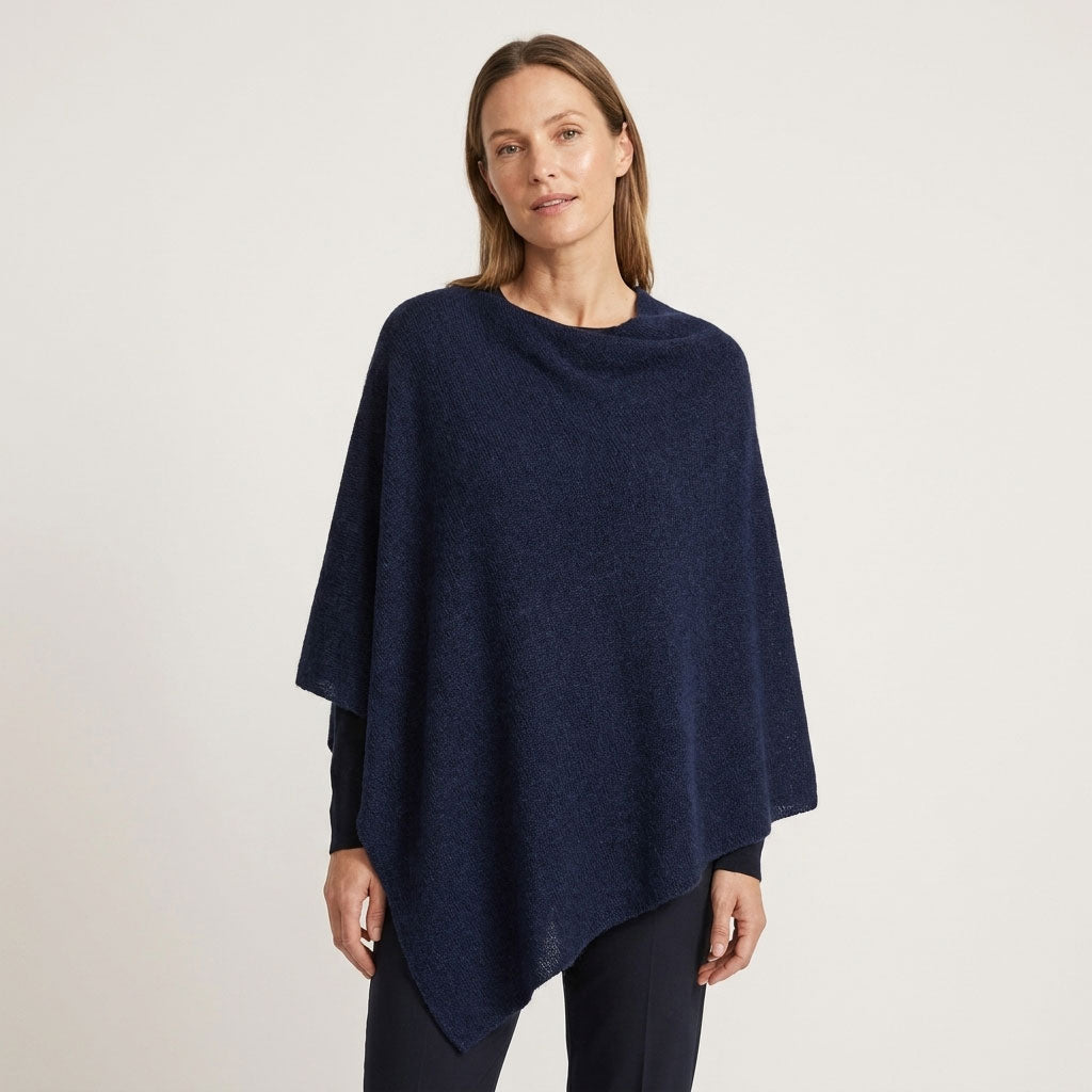 Sorpresa alpaca poncho in Navy Melange, a deep textured navy shade, shown on a female model