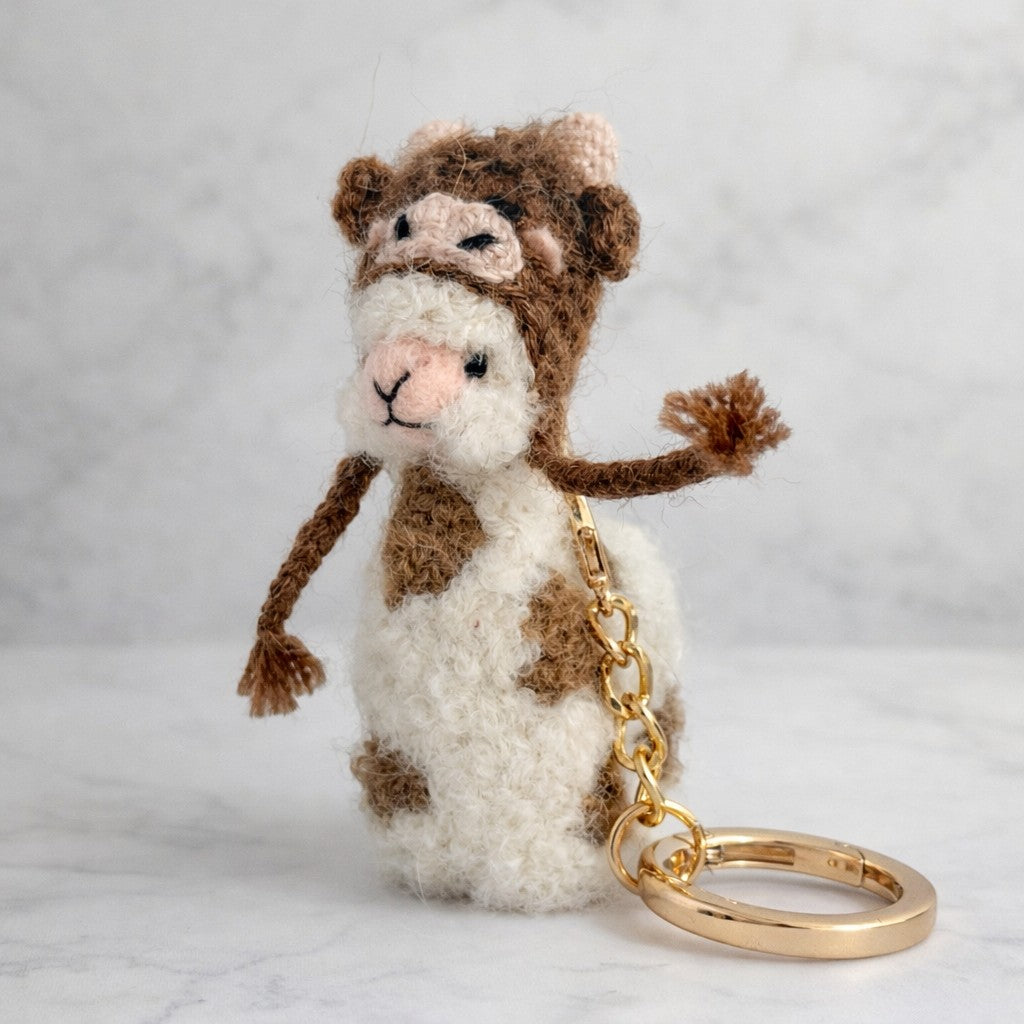 Handmade alpaca figure on keyring with needle felted detail and cow hat