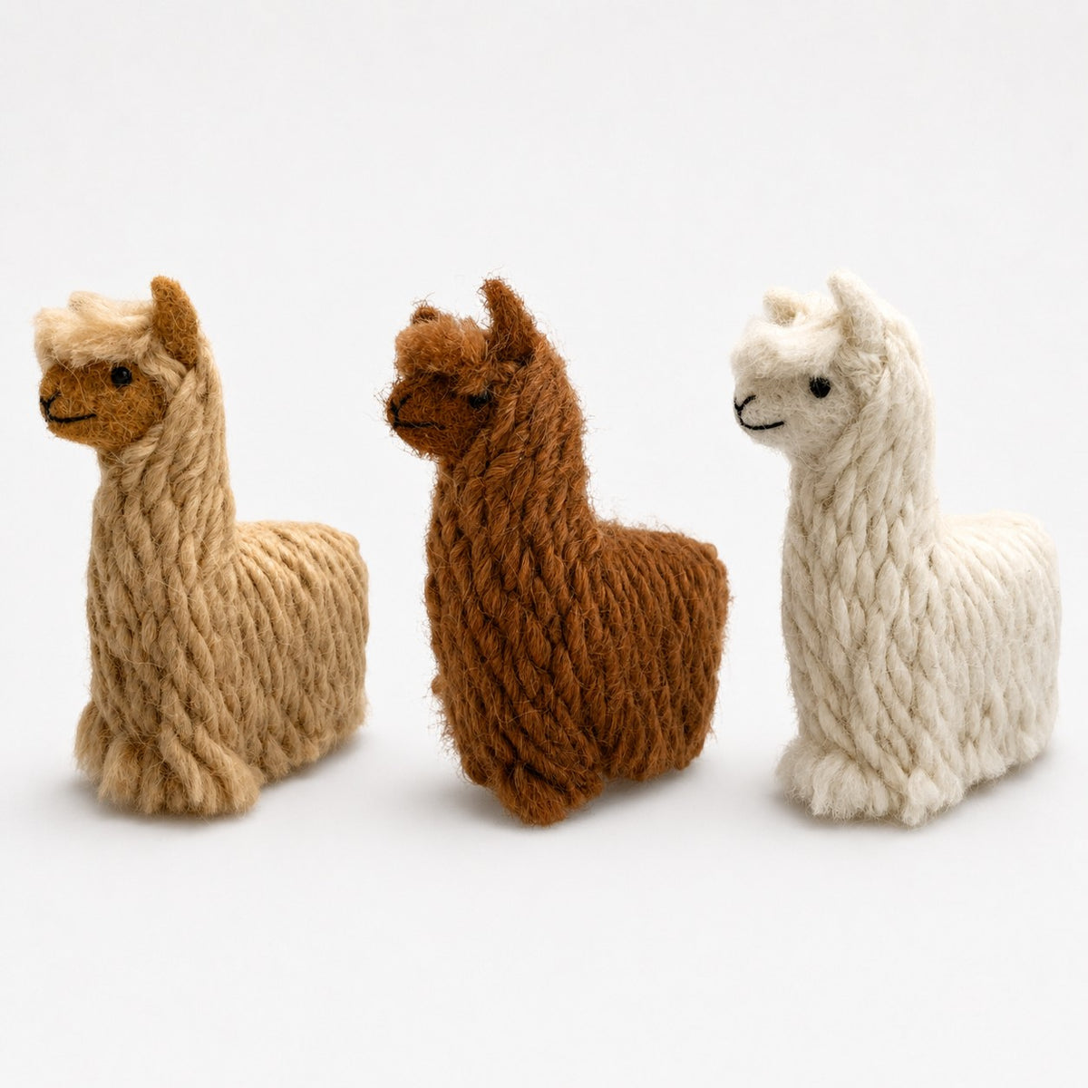 Three handmade felted suri alpaca decorations in natural tones, cute alpaca gifts.