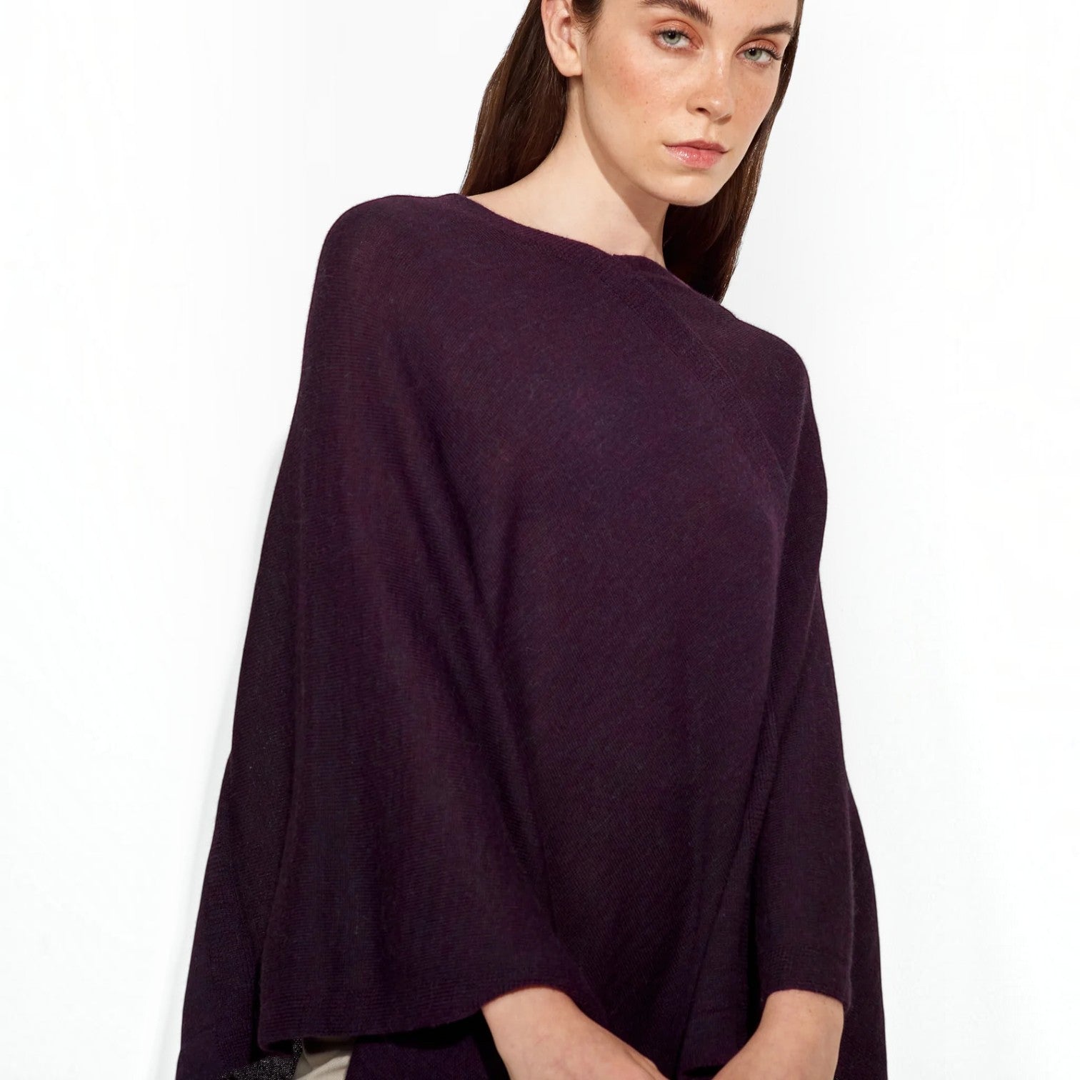 Close-up of the soft knit texture and neckline of the deep plum Baby Alpaca poncho