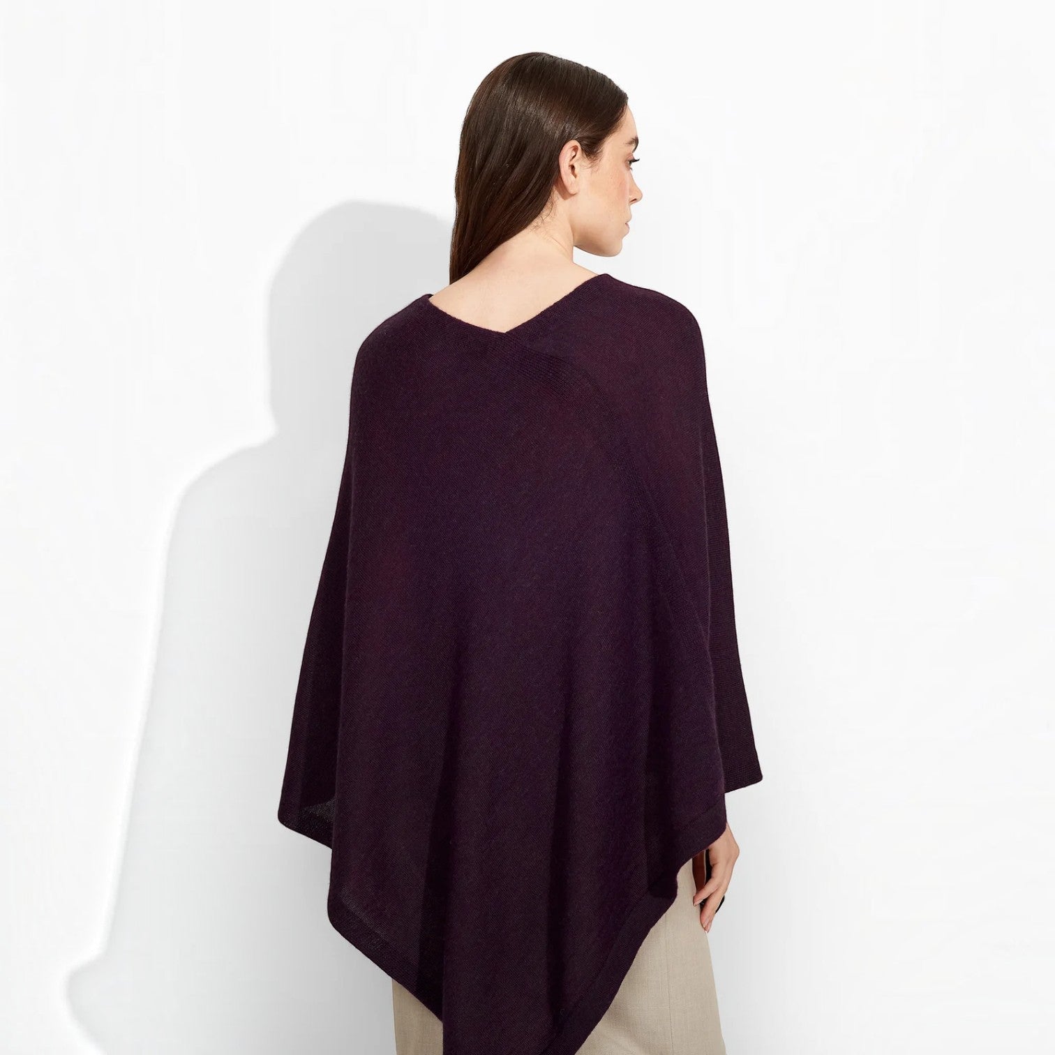 Back view of the deep plum Almendra women’s Baby Alpaca poncho