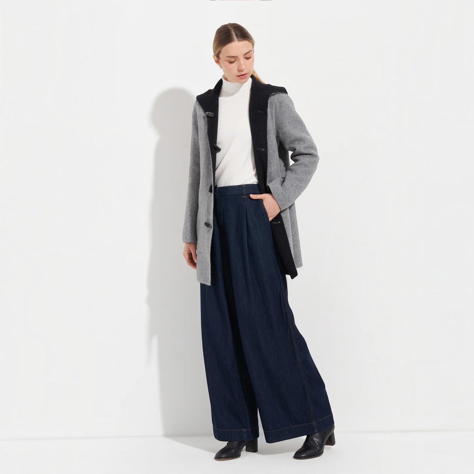 Women’s black reversible coat with grey trim and large front pockets