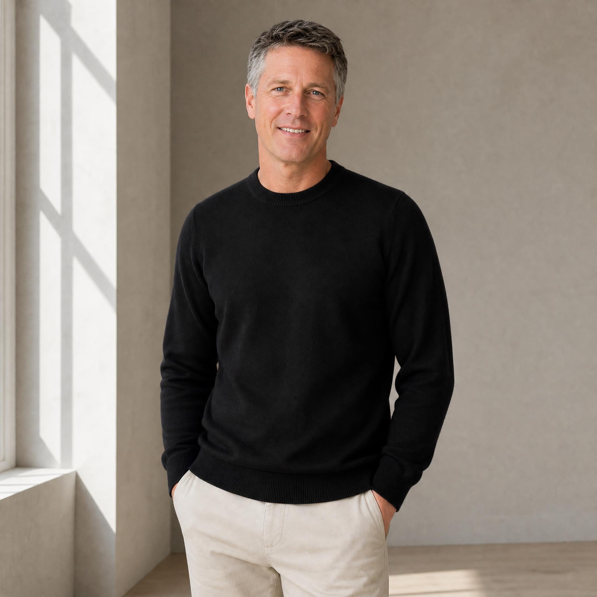 Model wearing Men’s natural fibre  crew neck sweater in alpaca cashmere blend in black